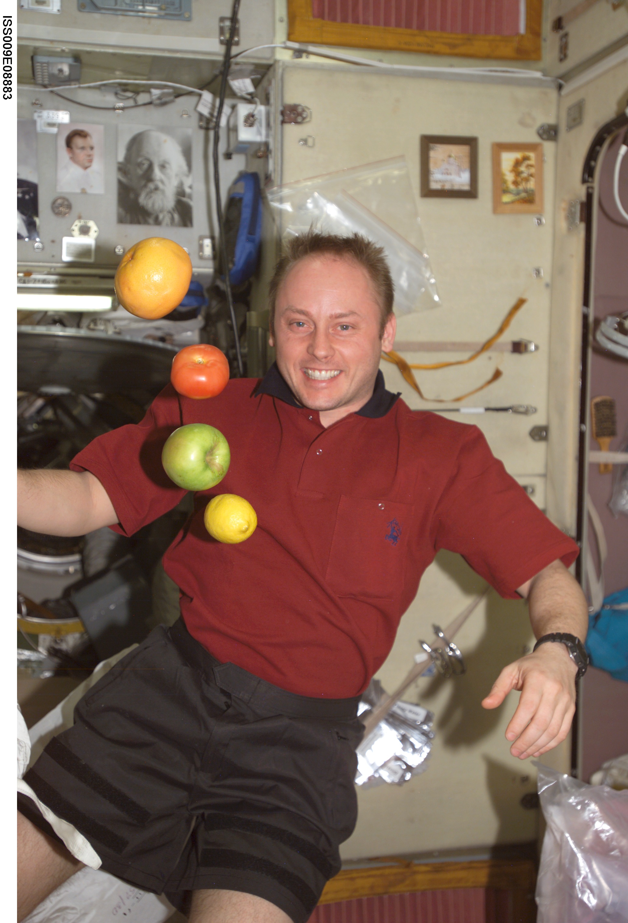 Fincke watches as fruit floats in the Service Module during Expedition 9