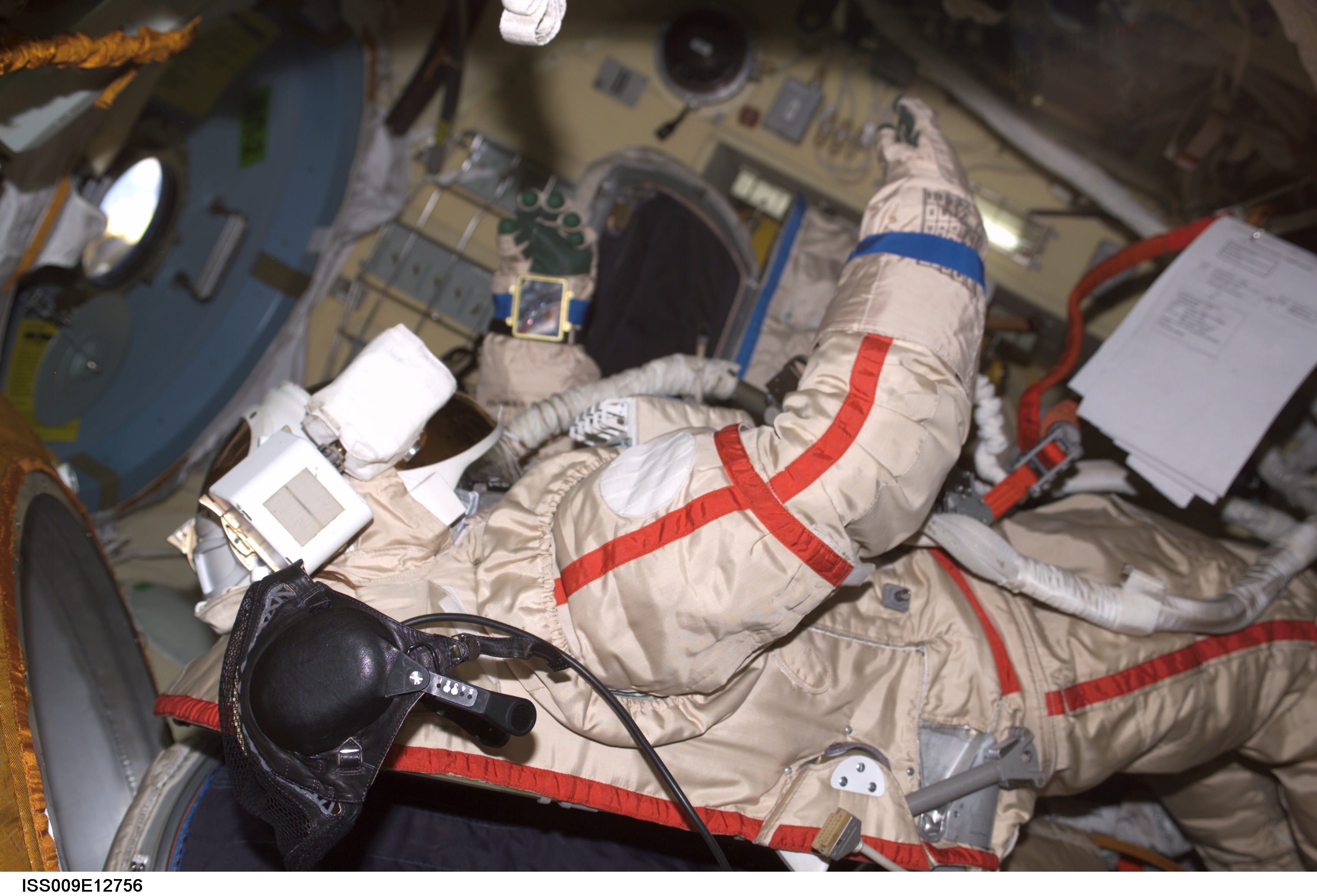 A Russian Orlan suit floats in the DC during suit checkout OPS before an EVA during Expedition 9