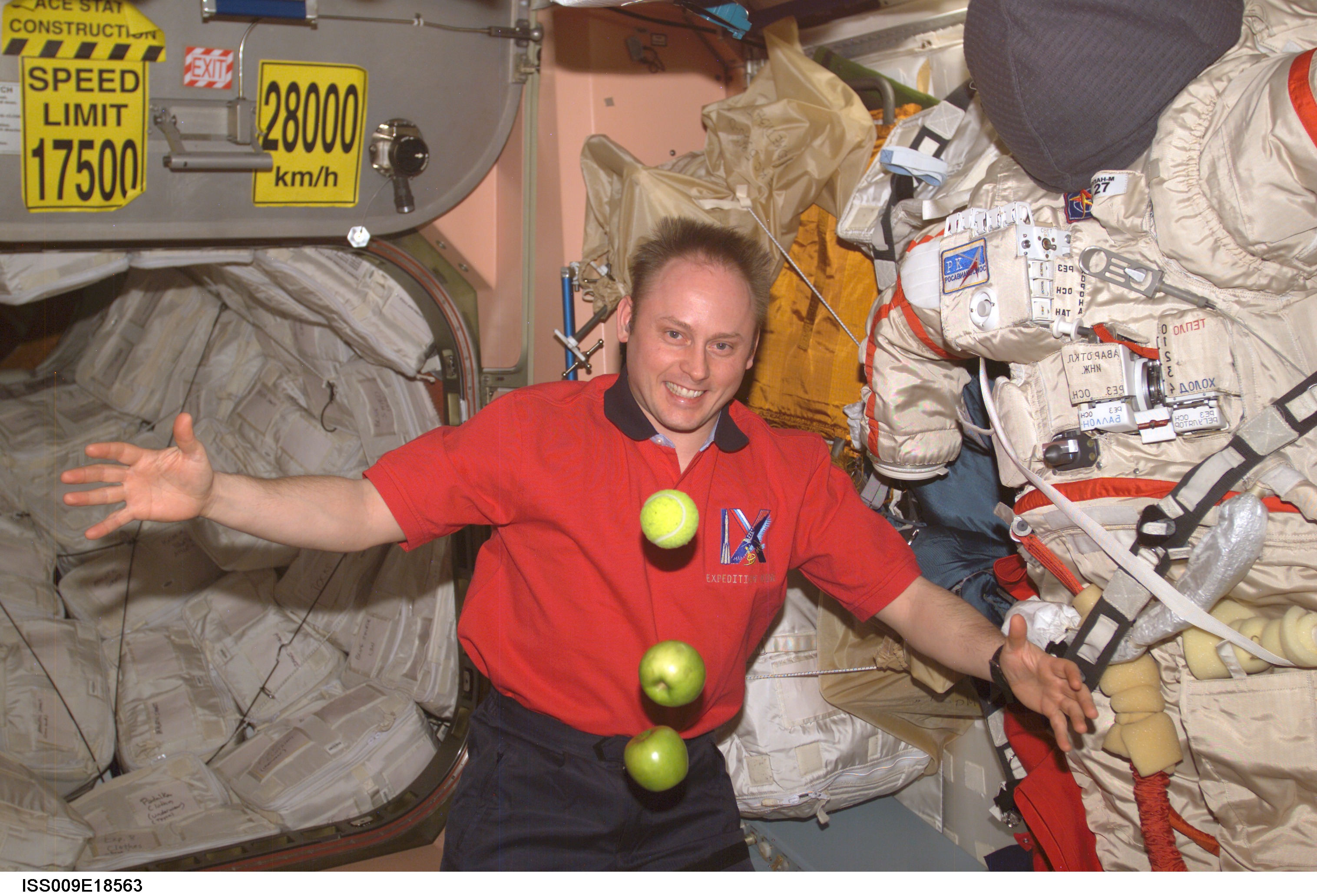 Fincke watches apples and a tennis ball float in the Service Module during Expedition 9