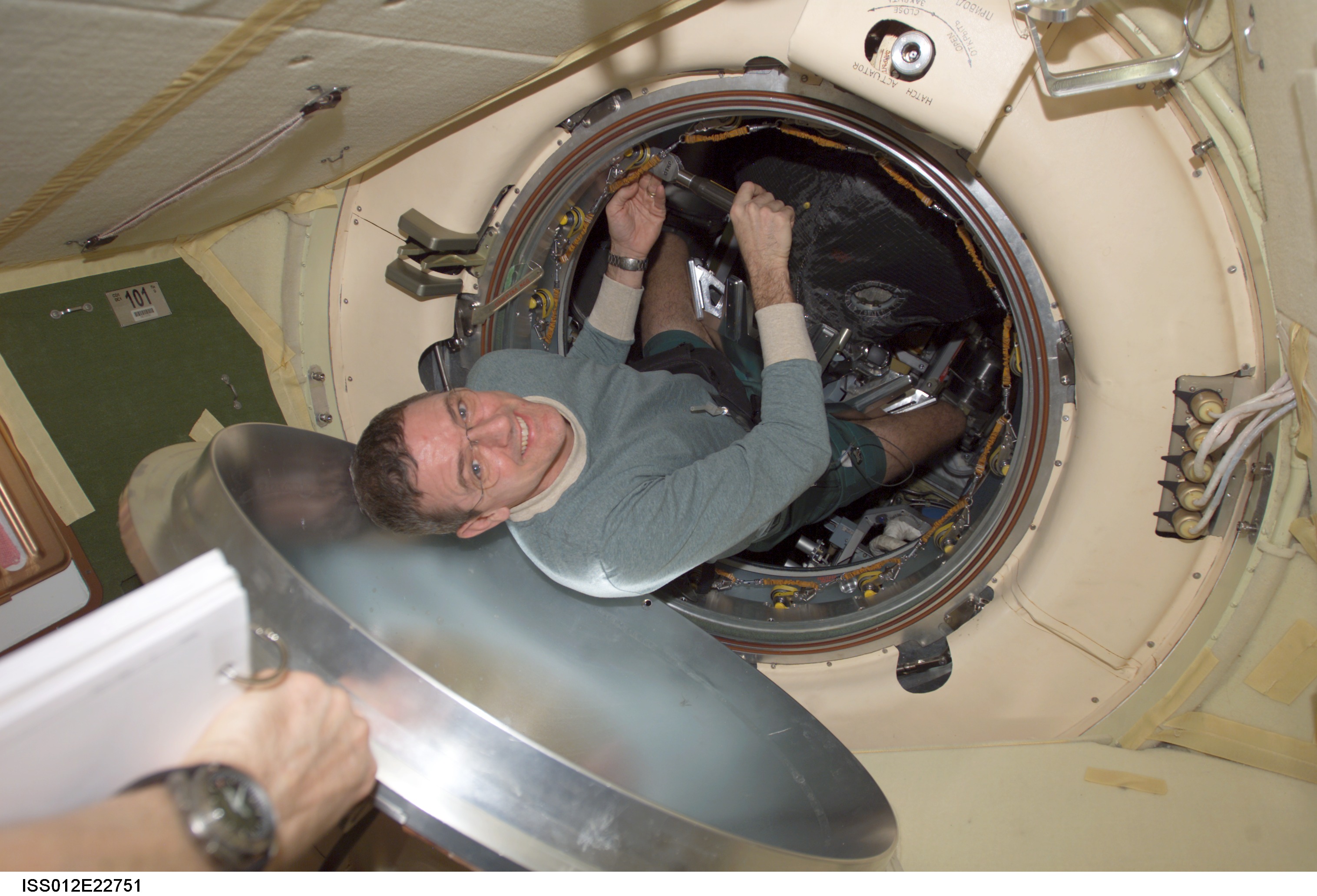McArthur works on the latch mechanisms of the Progress 20P hatch on Expedition 12