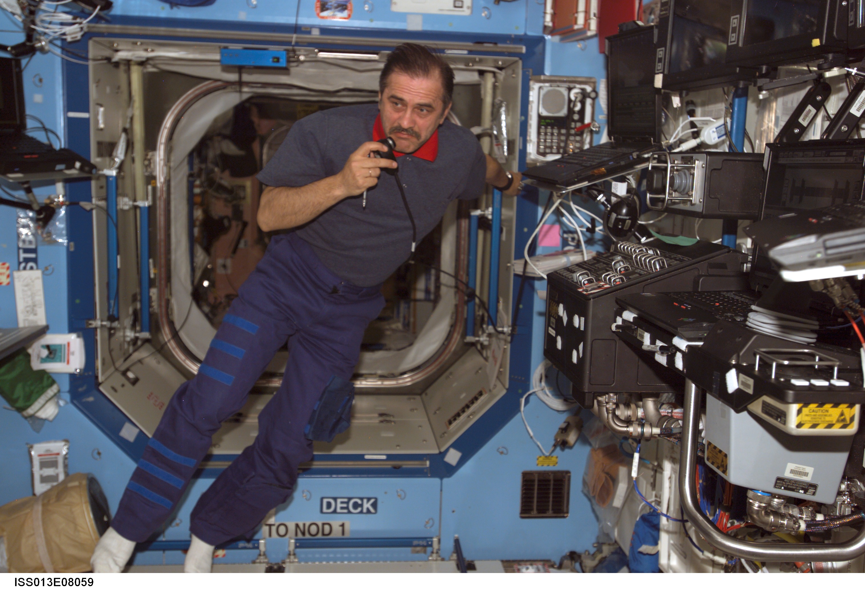 Vinogradov uses communication equipment in the U.S. Laboratory during Expedition 13