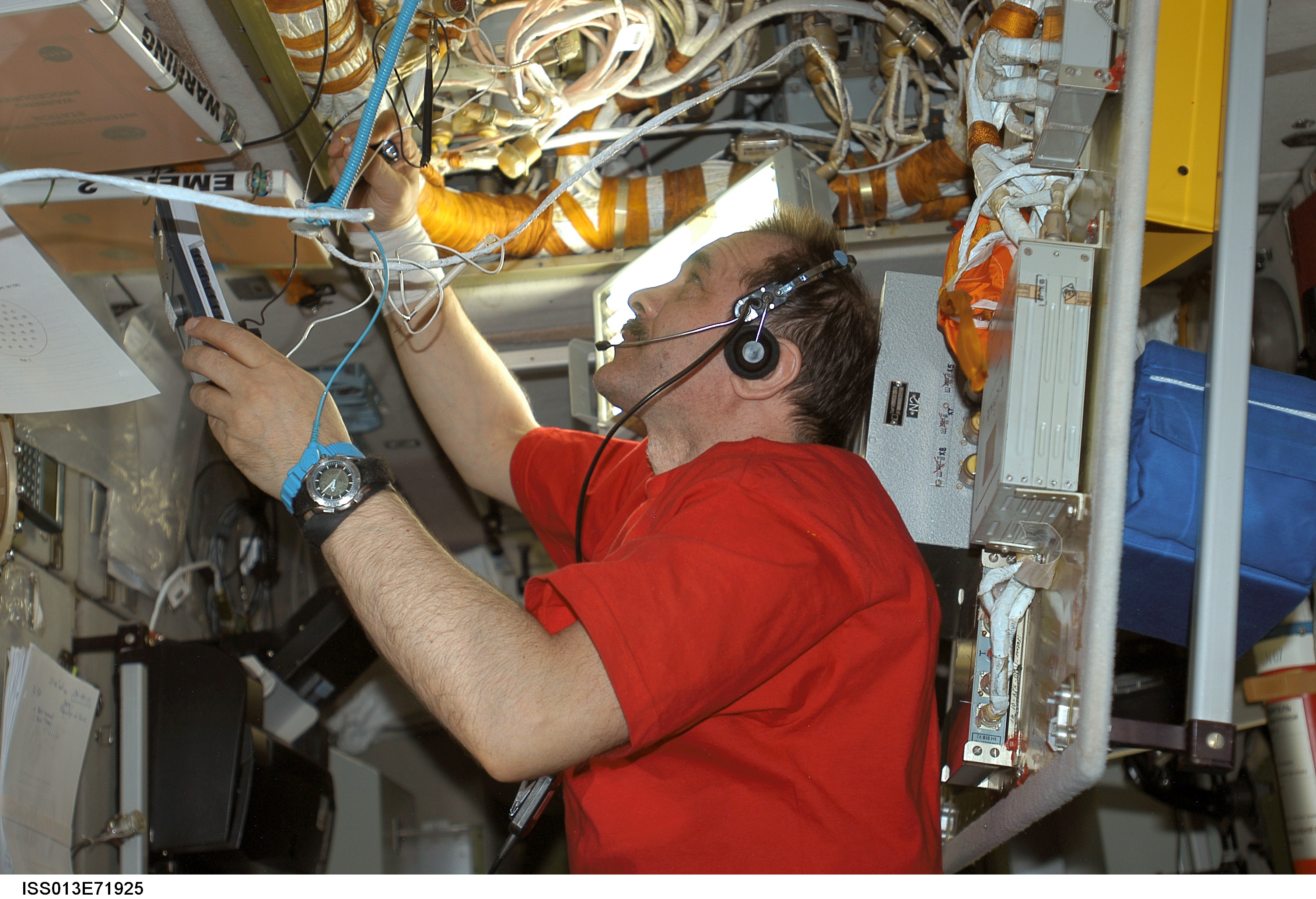 Vinogradov removes the light screen guards in the Pirs DC1 during Expedition 13