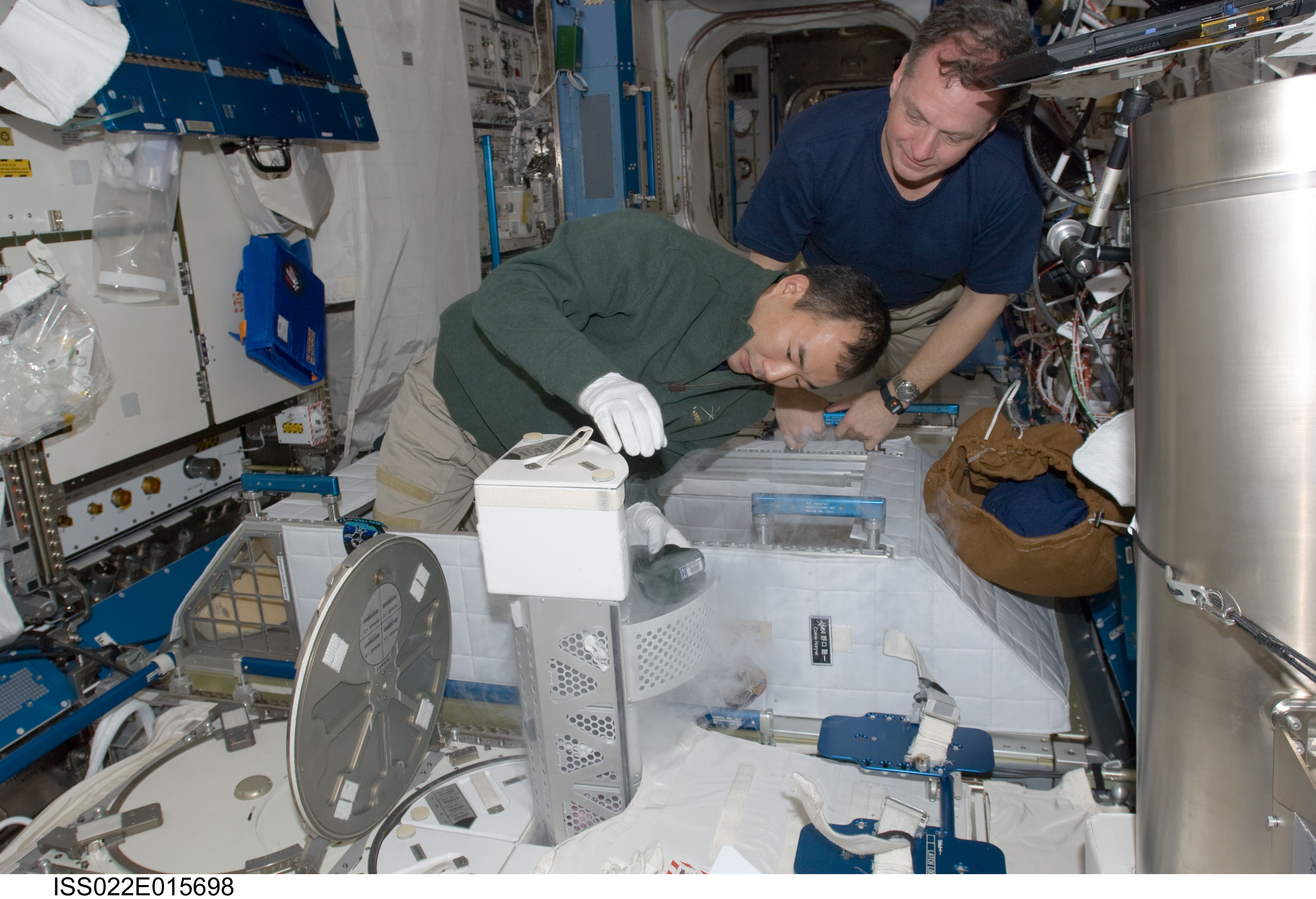 Noguchi and Creamer service the MELFI-1 in the JEM during Expedition 22