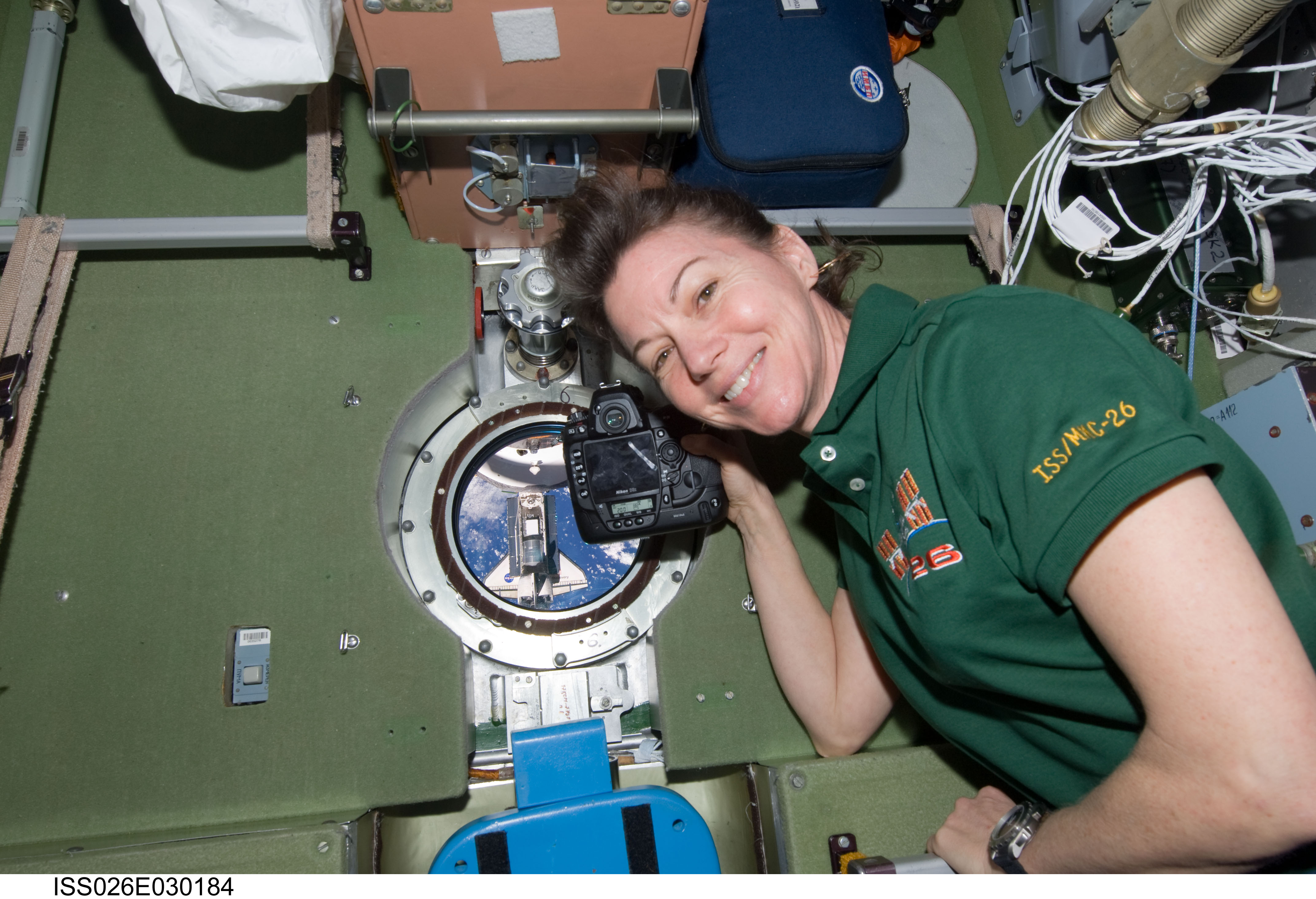 Coleman takes photos of STS-133 Discovery Approach