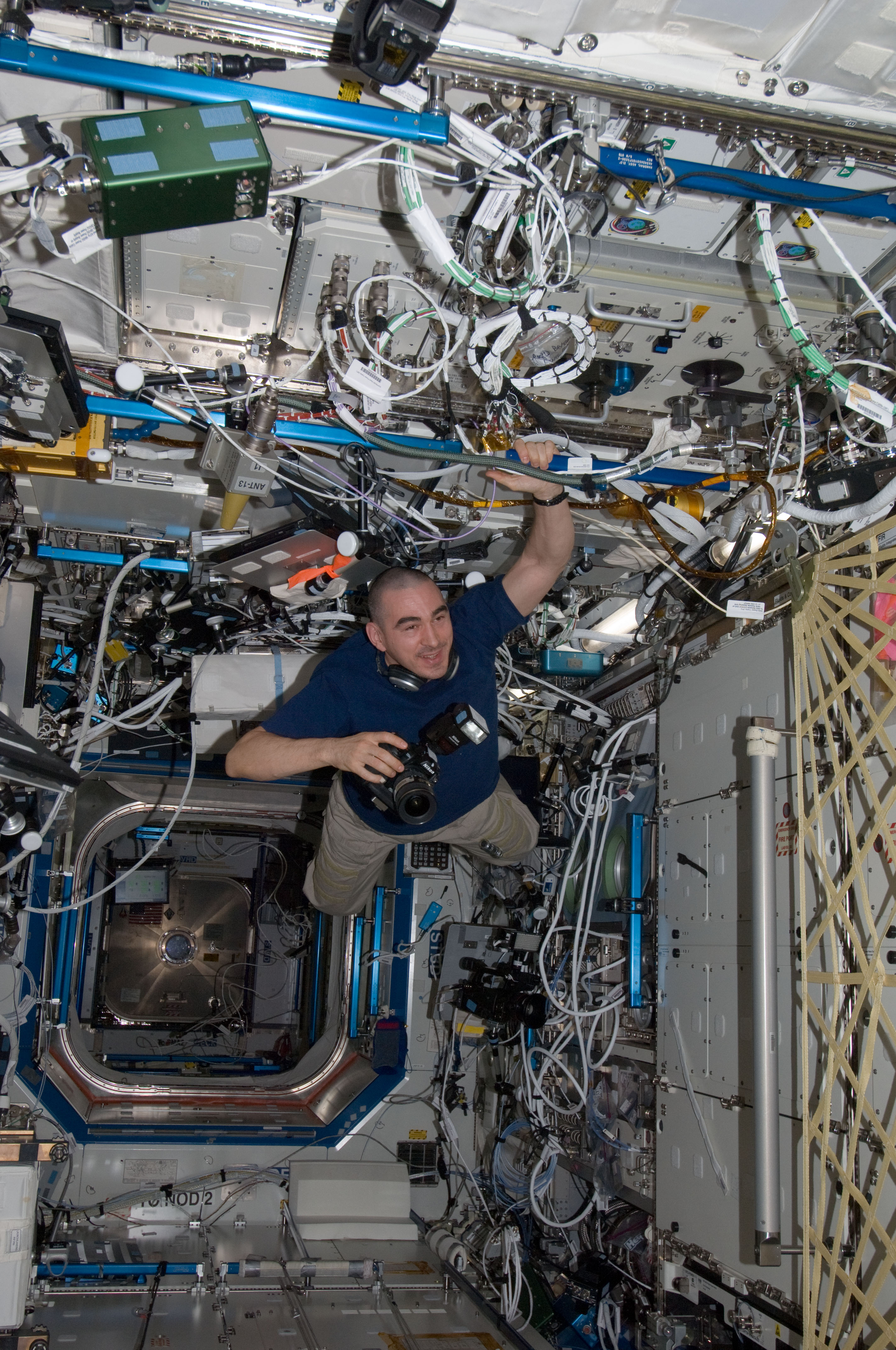 Ivanishin holds a still camera while floating through the U.S. Laboratory