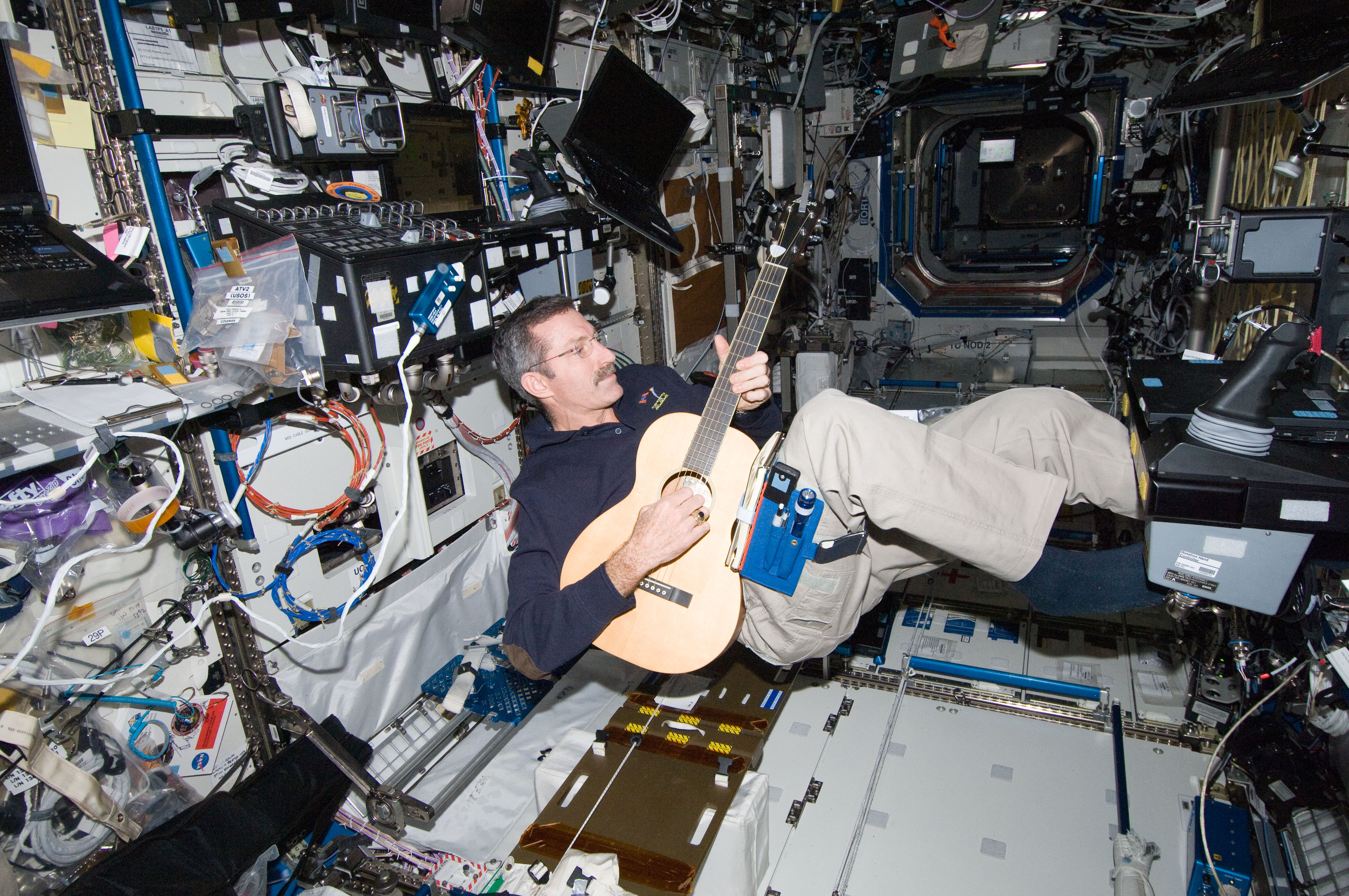 Burbank plays a guitar in the U.S. Laboratory
