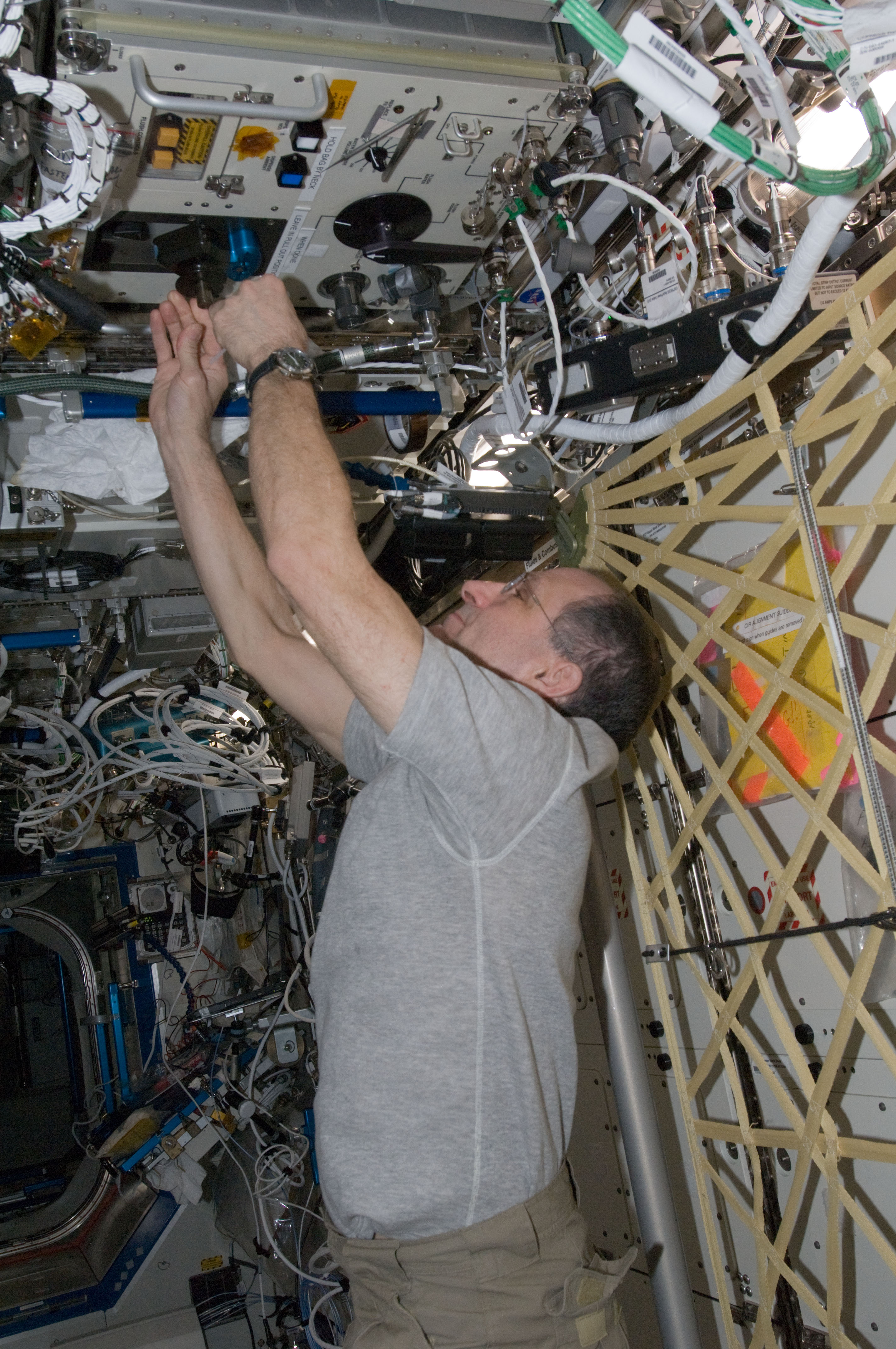 Pettit performs an in-flight maintenenace on the PWD in the U.S. Laboratory