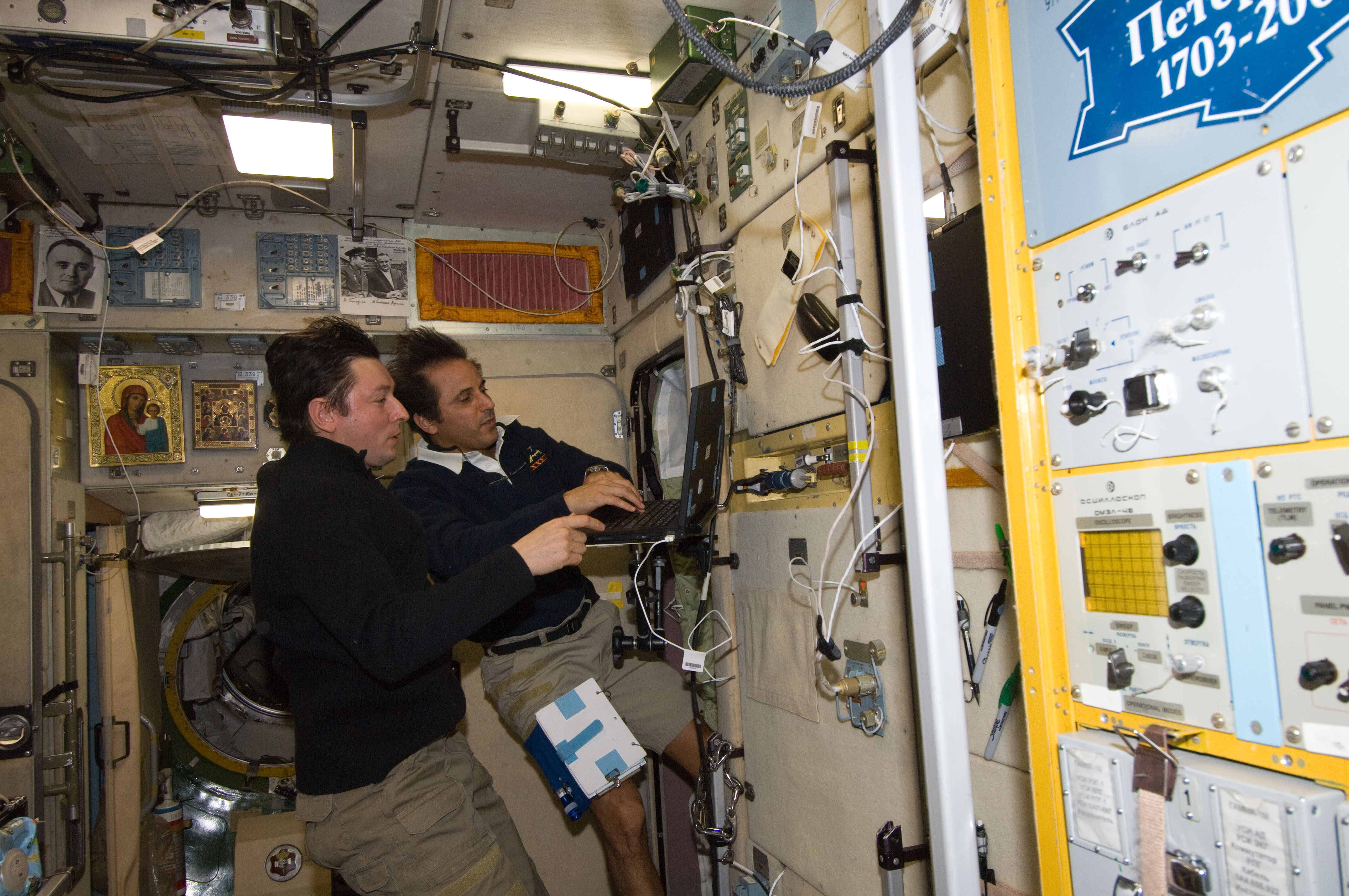 Expedition 32 Crew Members work in the SM