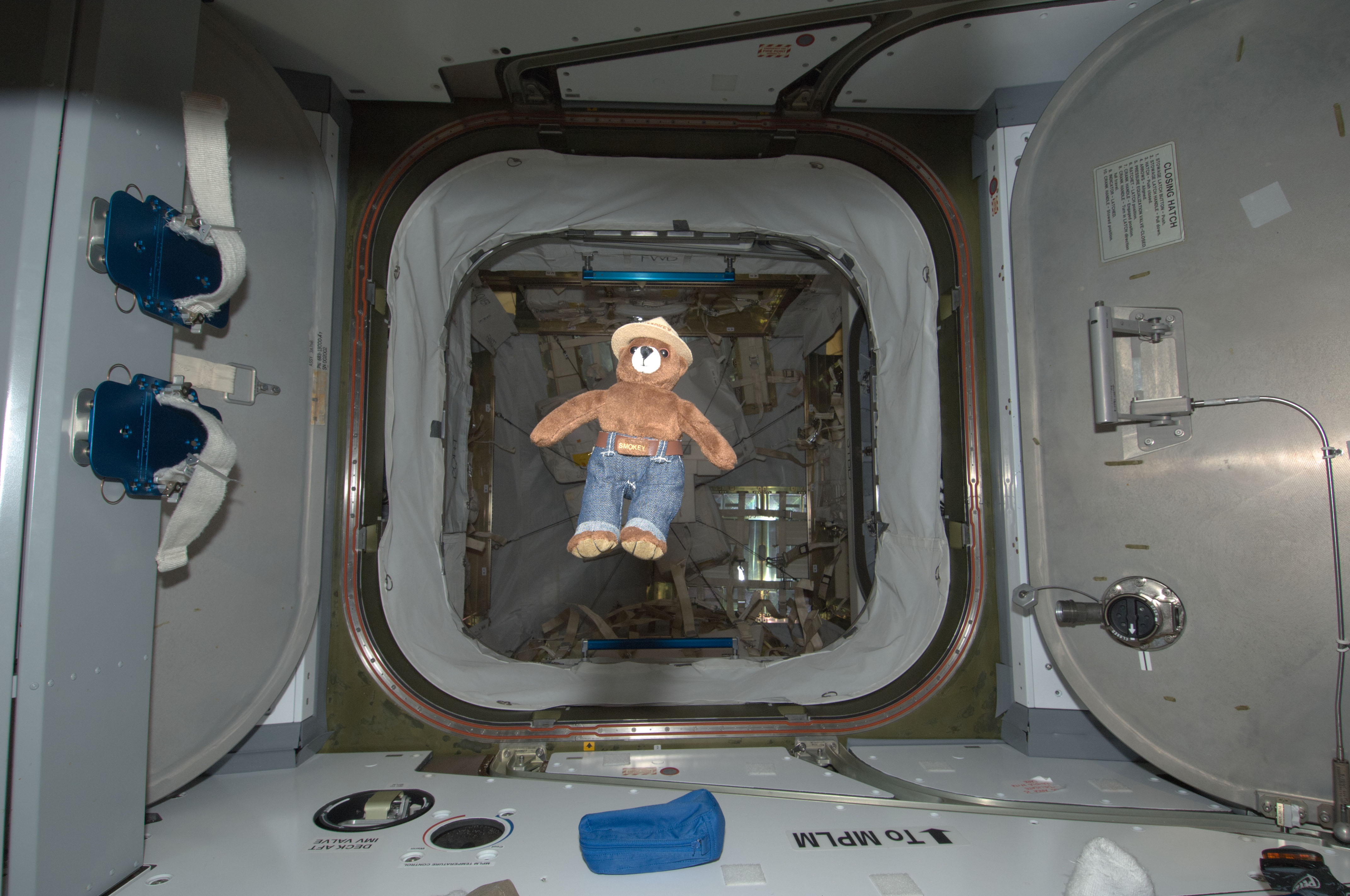 Smokey the Bear Toy floating in ISS Hatchway