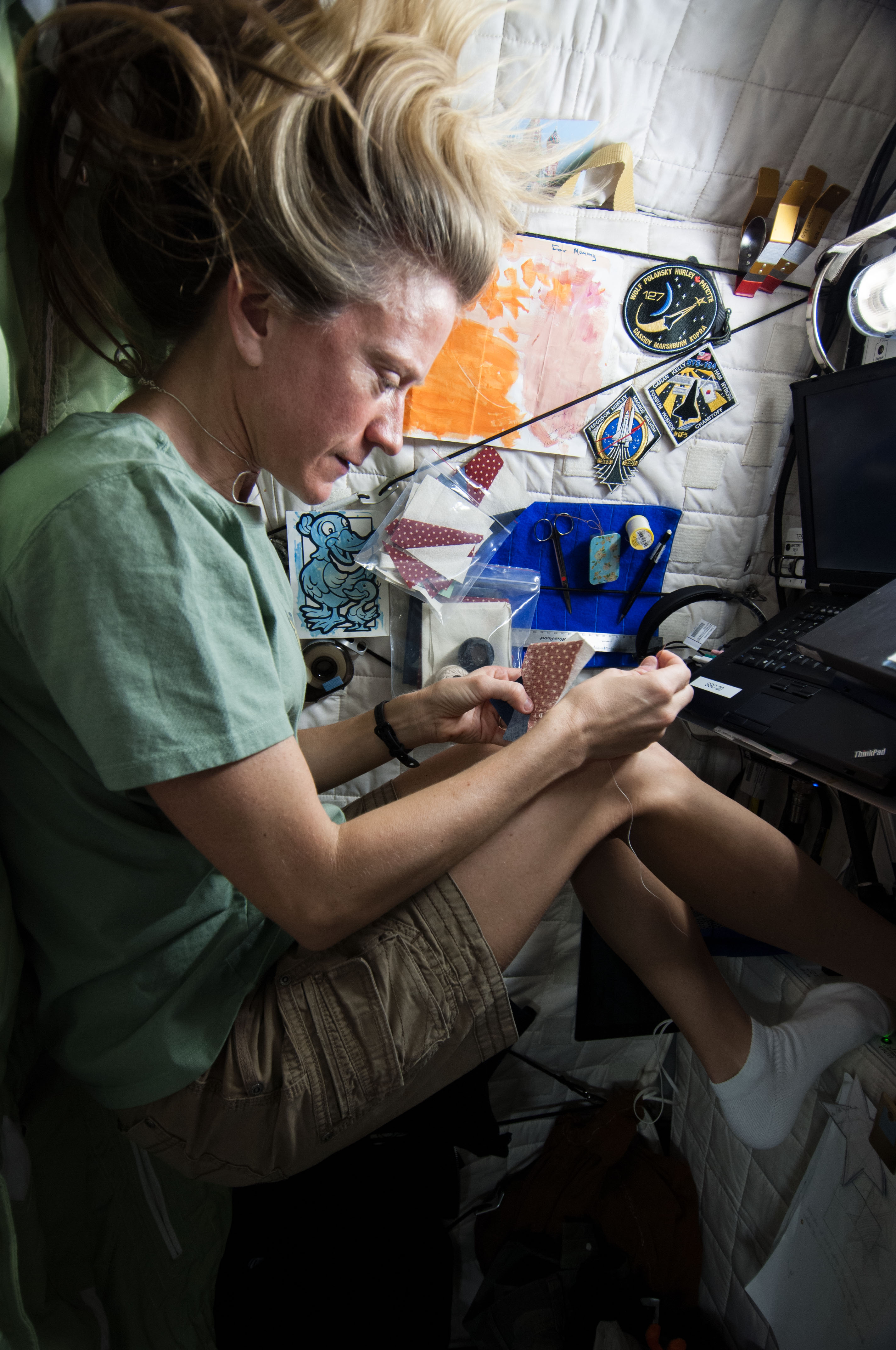 Nyberg sewing in Crew Quarters