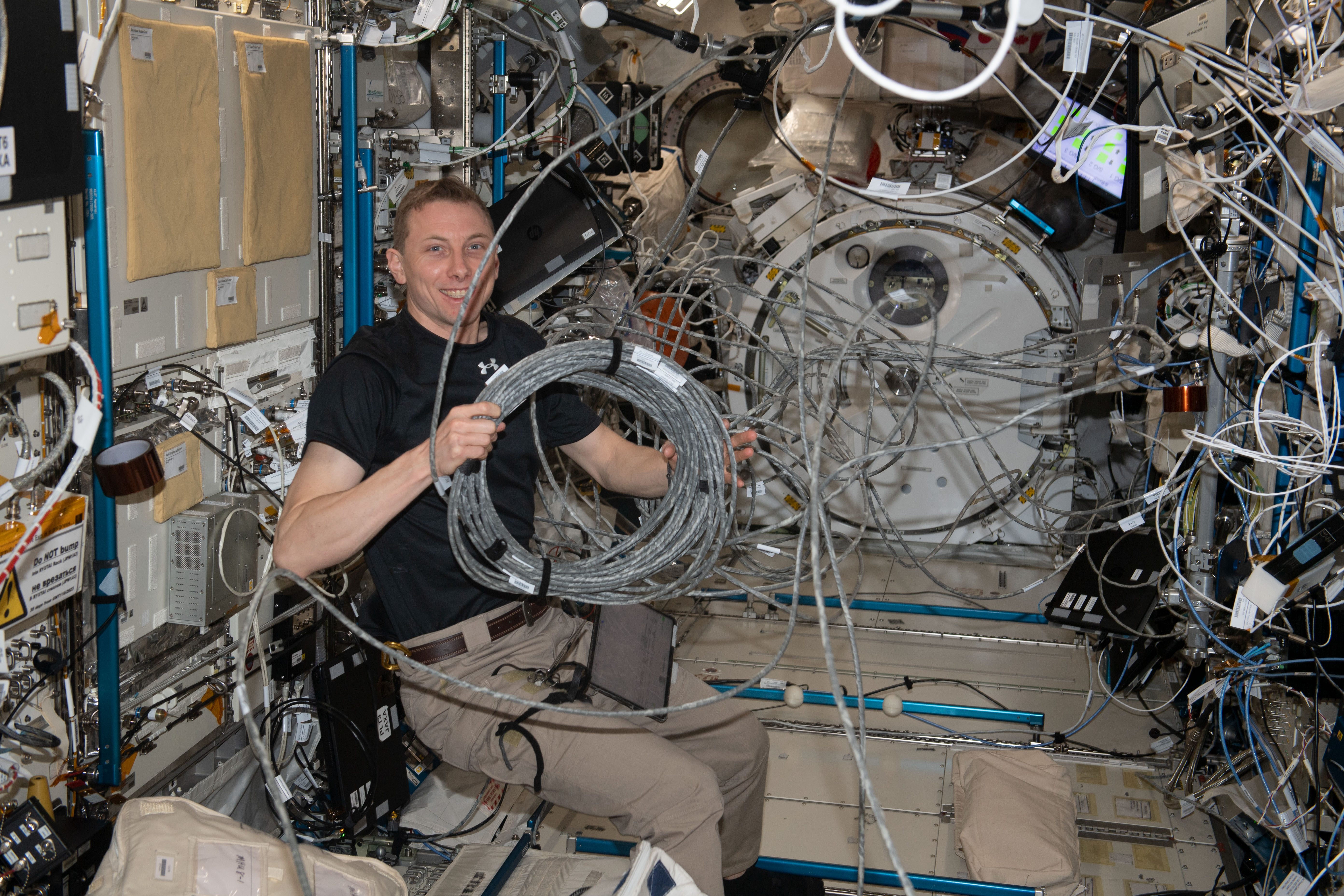 Astronaut Woody Hoburg reconfigures video cables