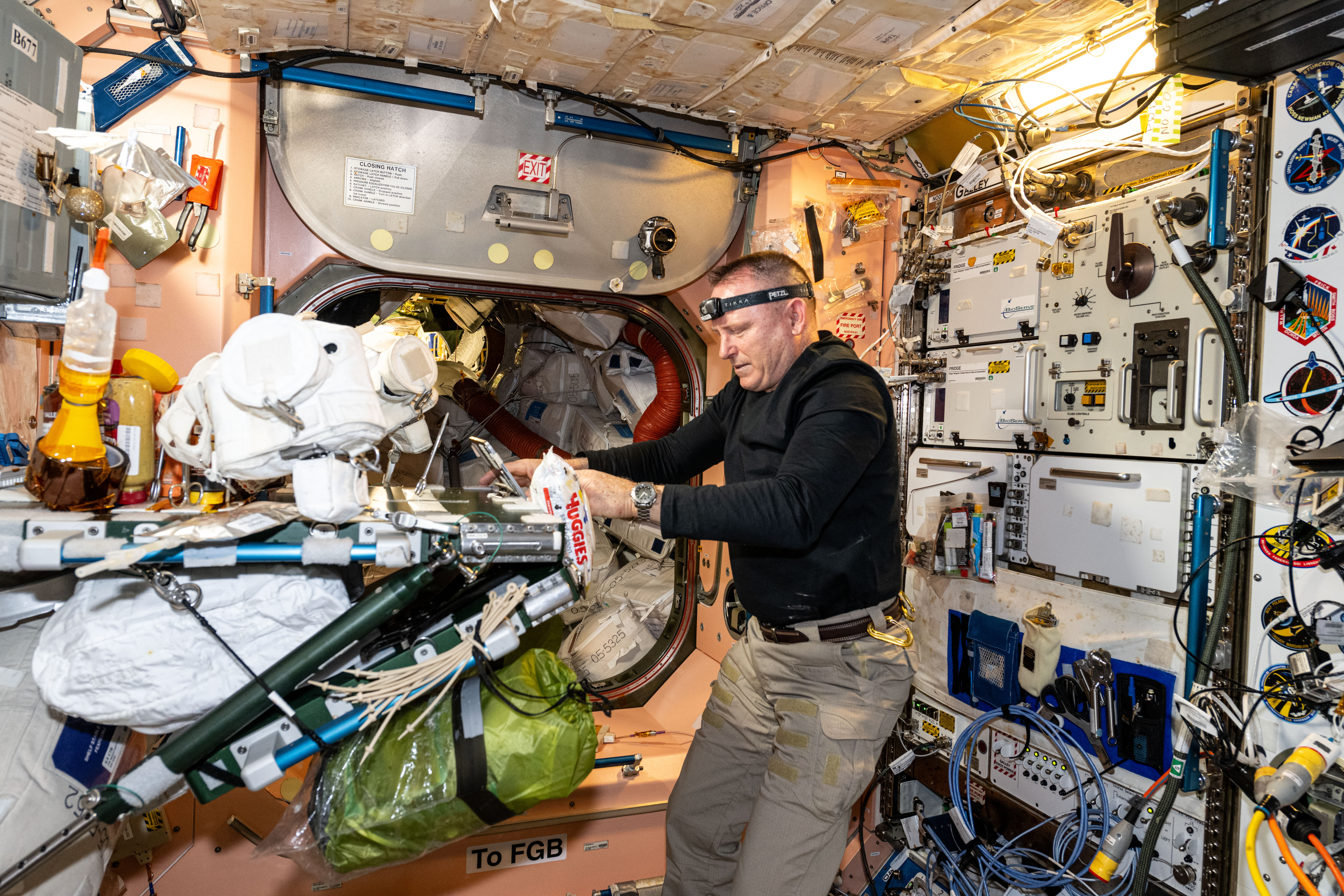 Astronaut Butch Wilmore configures spacewalking hardware