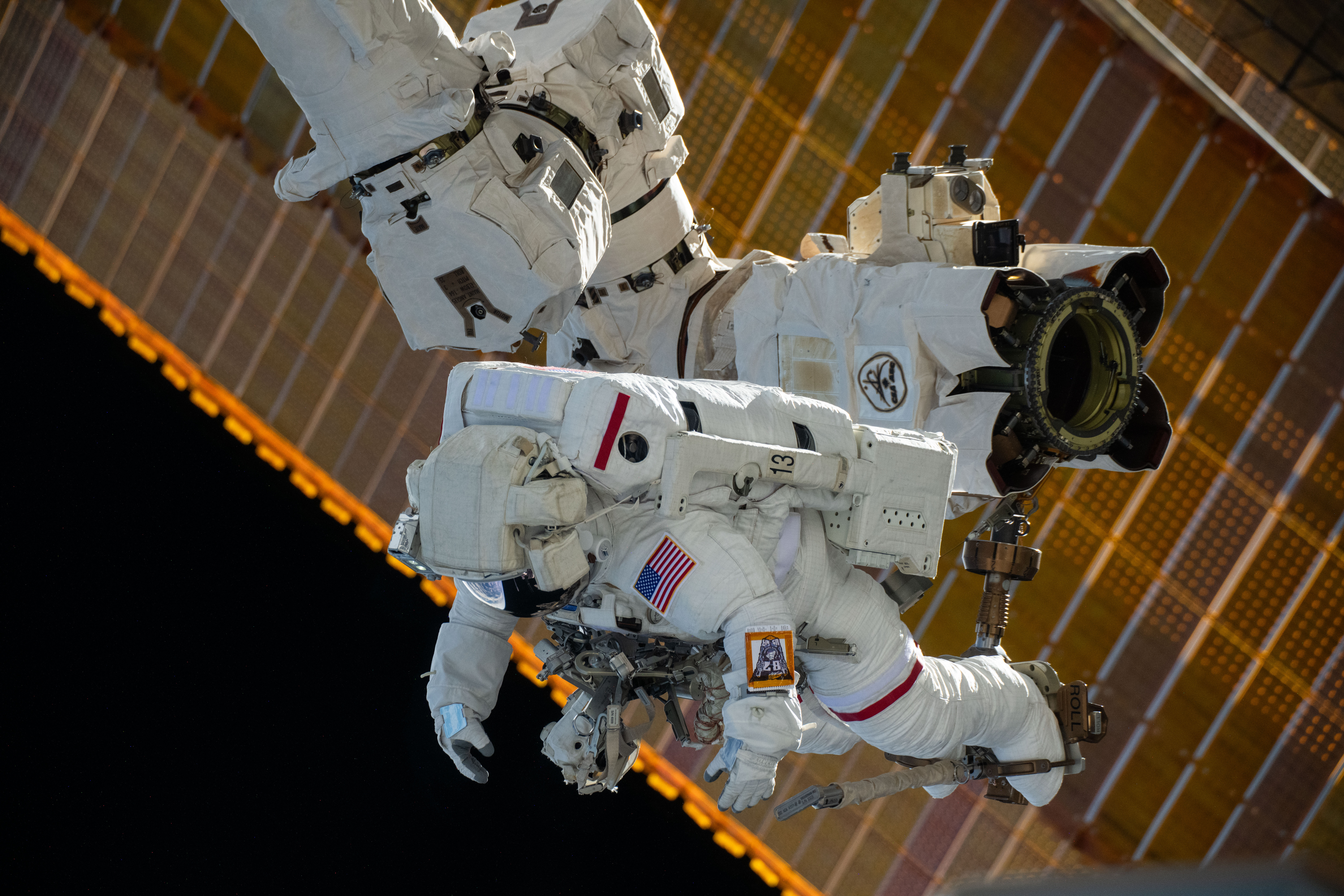 Astronaut is attached to the Canadarm2 robotic arm's latching end effector
