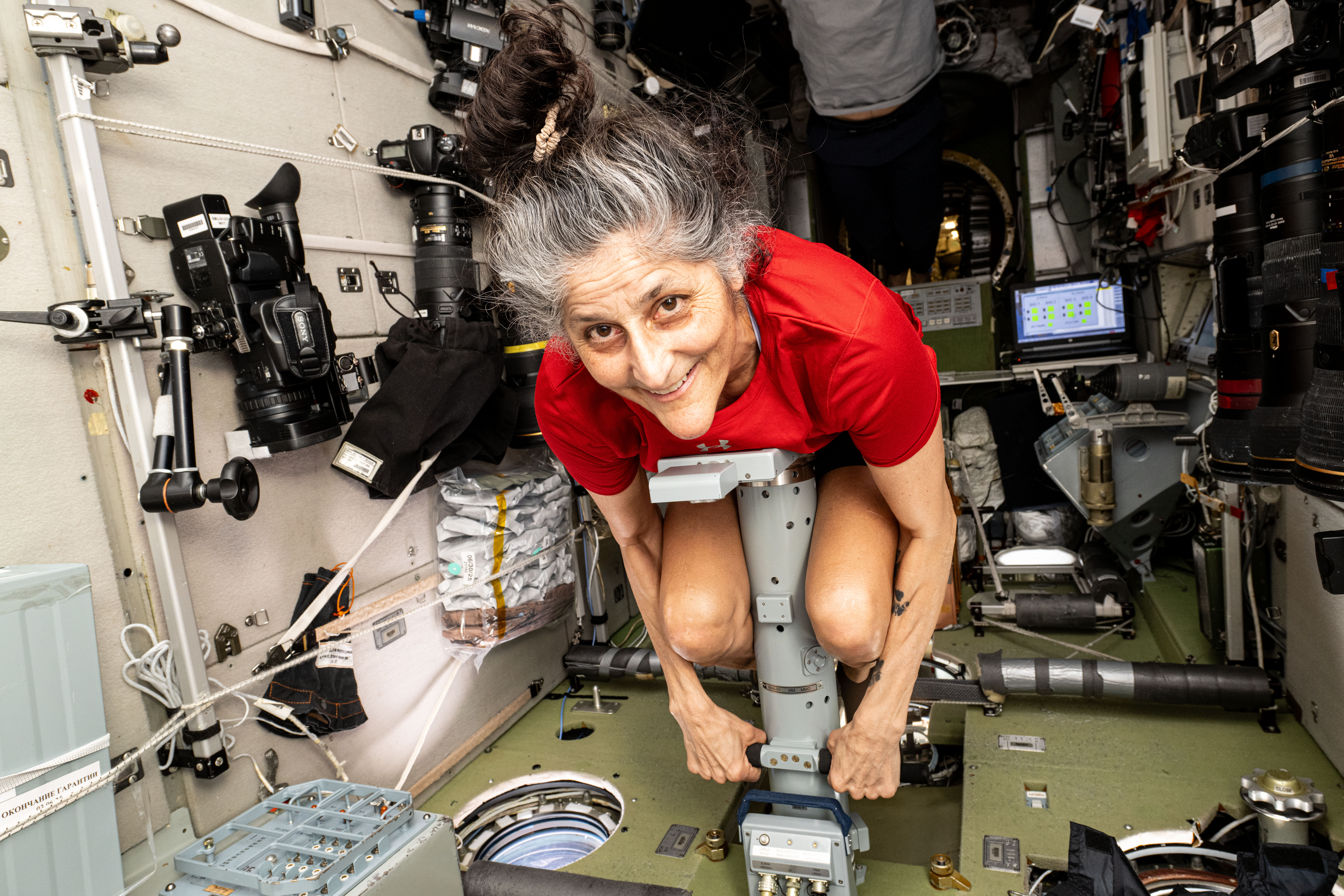 Astronaut Suni Williams measures her mass using a specialized device
