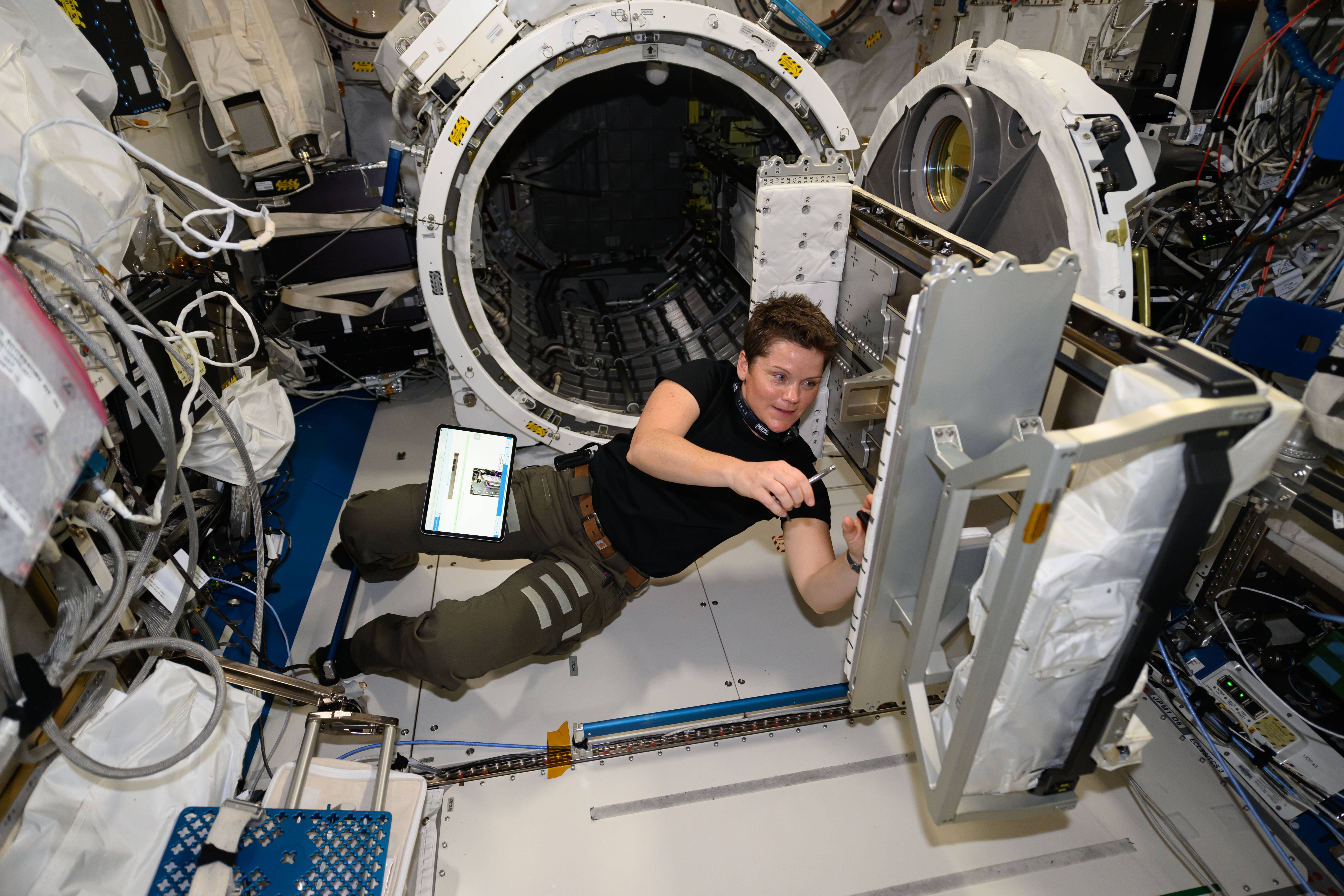 Astronaut Anne McClain hardware maintenance tasks inside the Kibo laboratory module