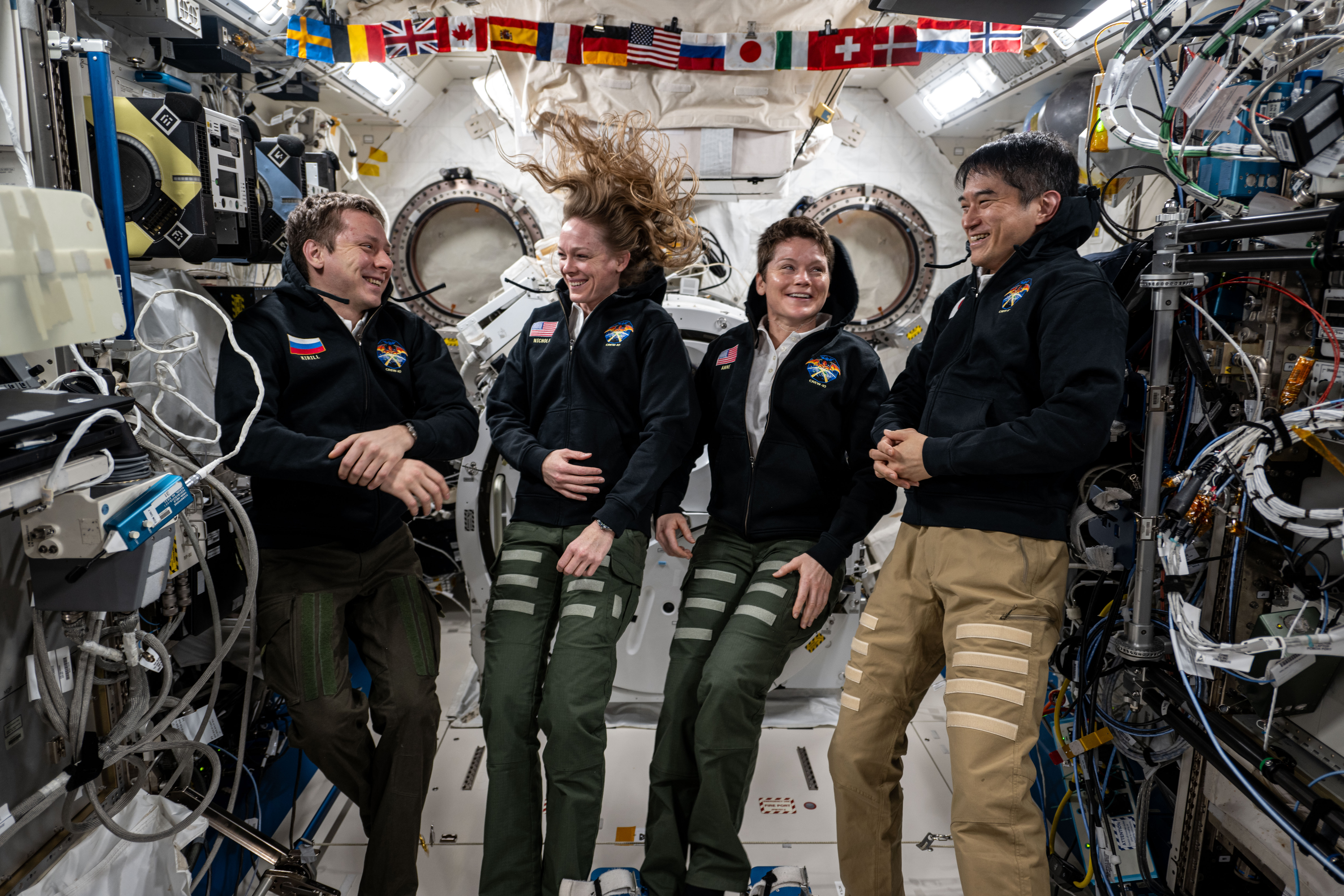 NASA's SpaceX Crew-10 members share a light moment during a group portrait