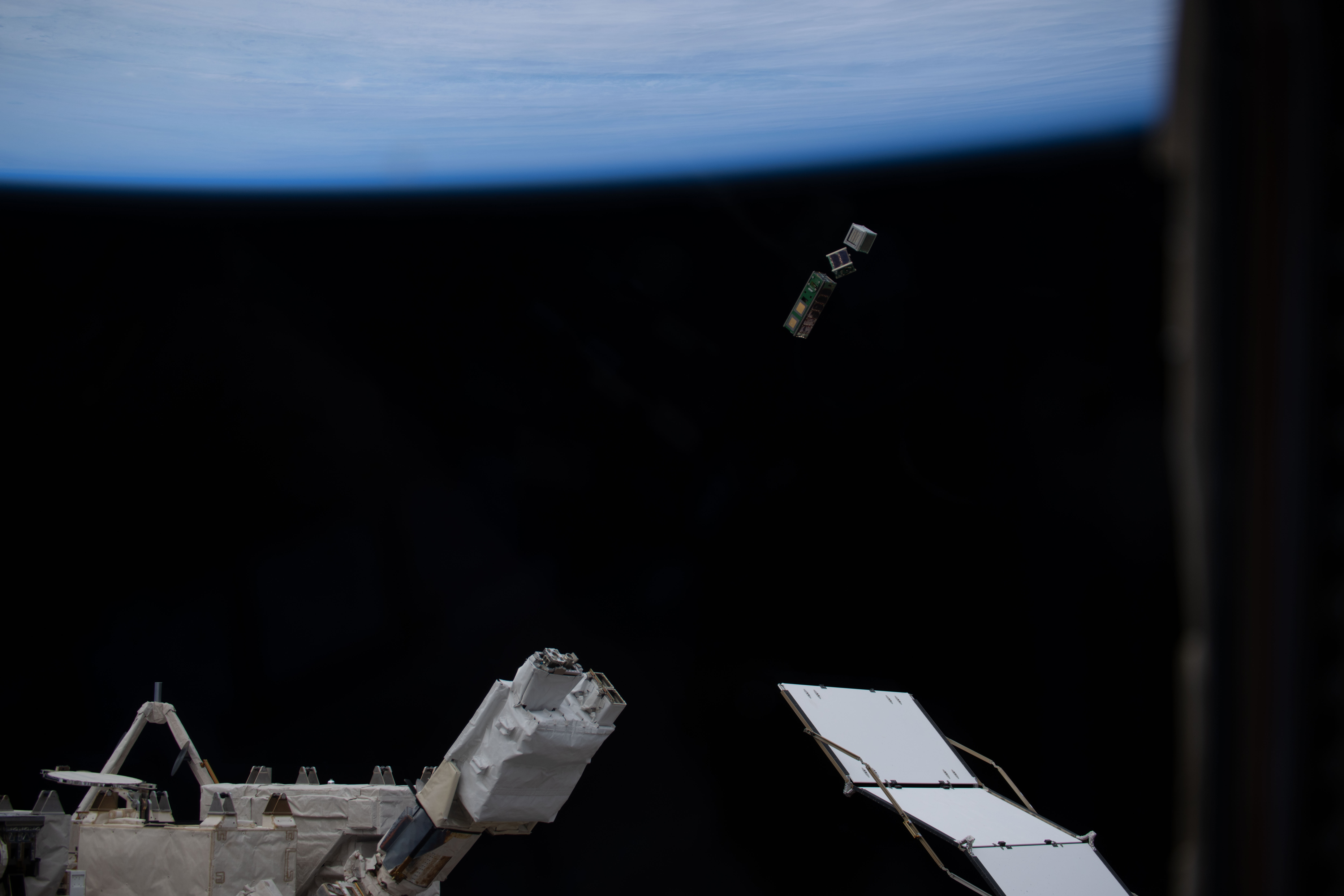 A trio of CubeSats is deployed into Earth orbit outside of the International Space Station