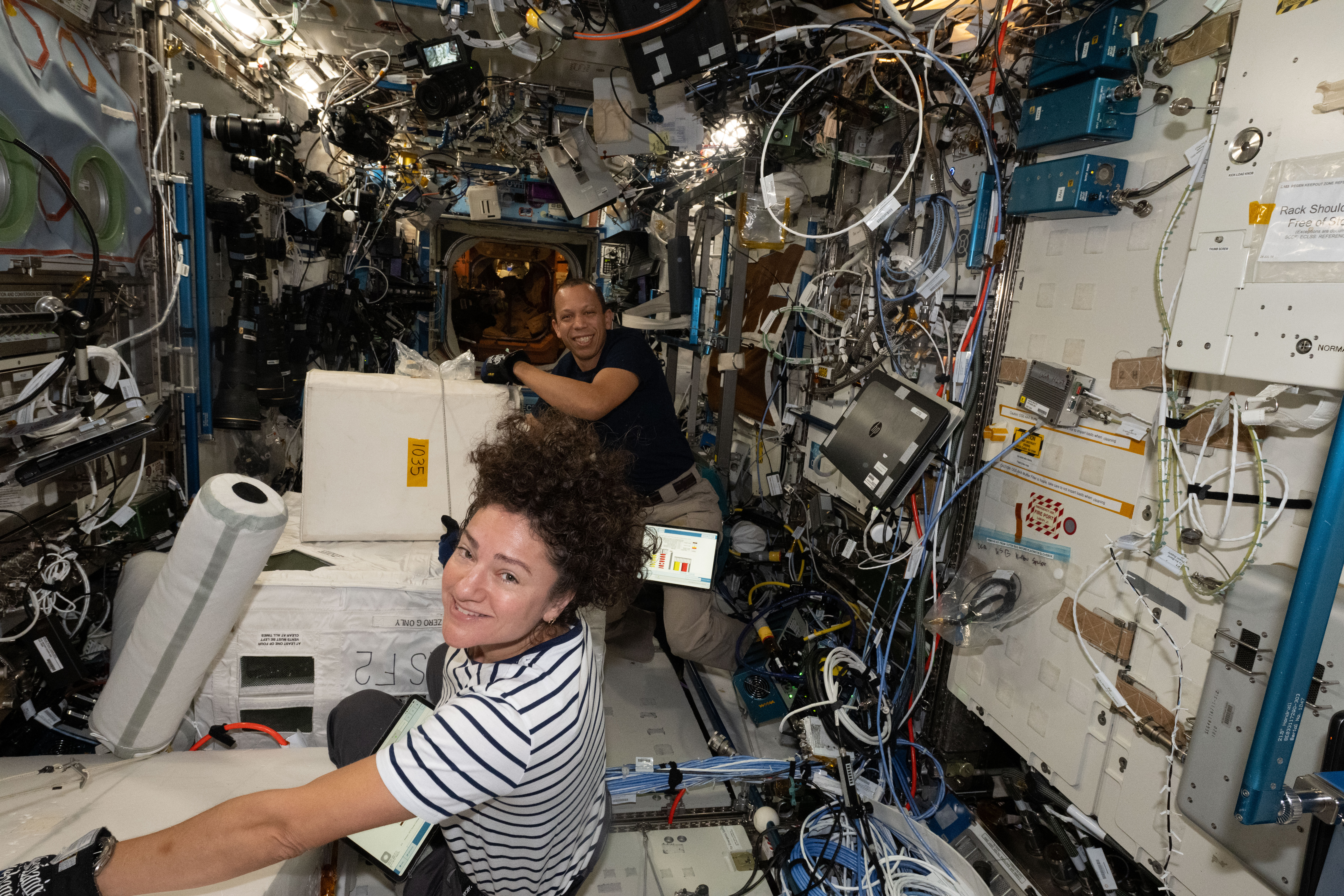 NASA astronauts Jessica Meir and Chris Williams collect frozen research samples