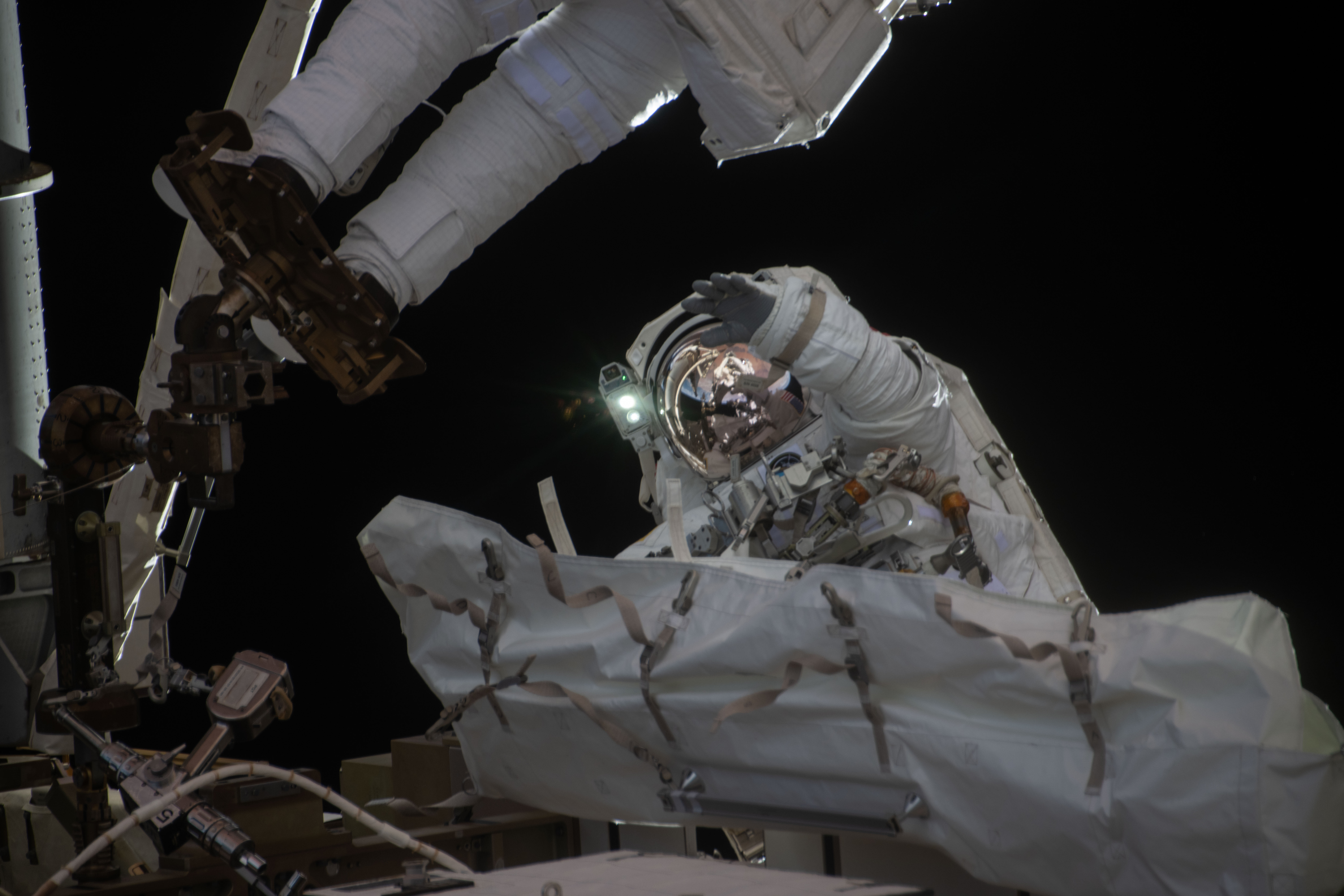 NASA astronaut Jessica Meir waves at the camera during a spacewalk