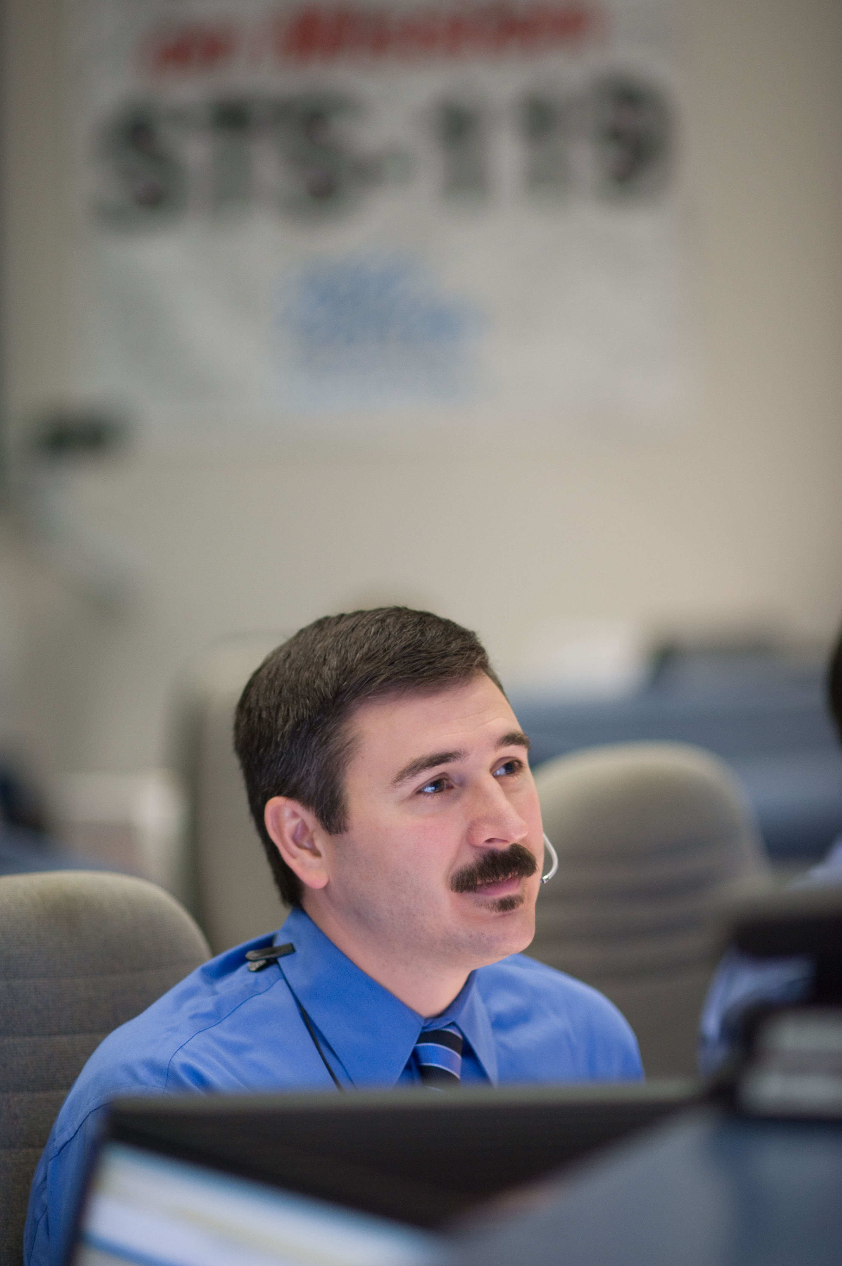 STS-119 Flight Director Mike Sarafin and flight controllers on console during the undocking and fly around phase.