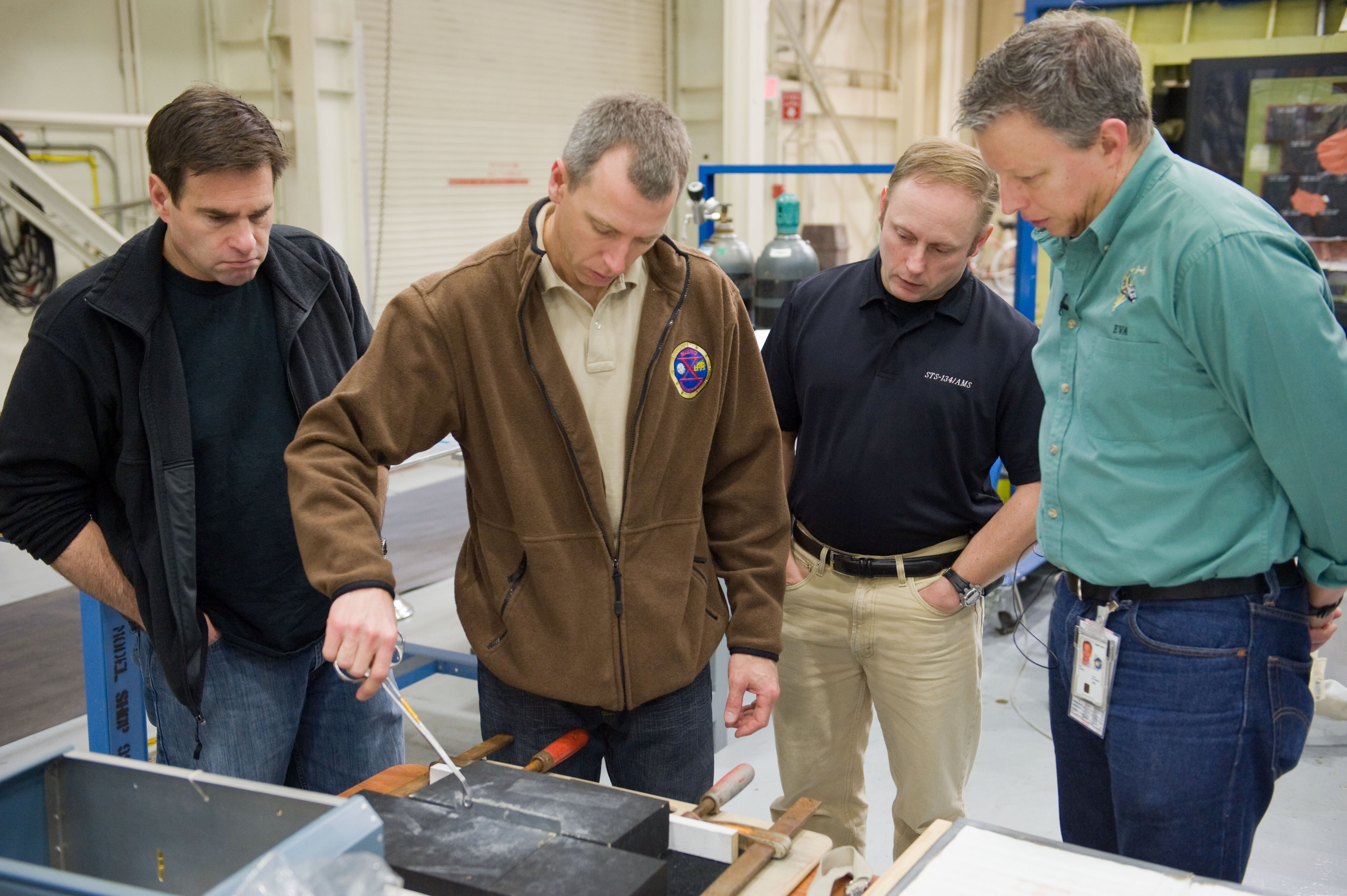STS-134 crew members Mike Fincke, Drew Feustel and Greg Chamitoff performing EVA Tile Repair Training.