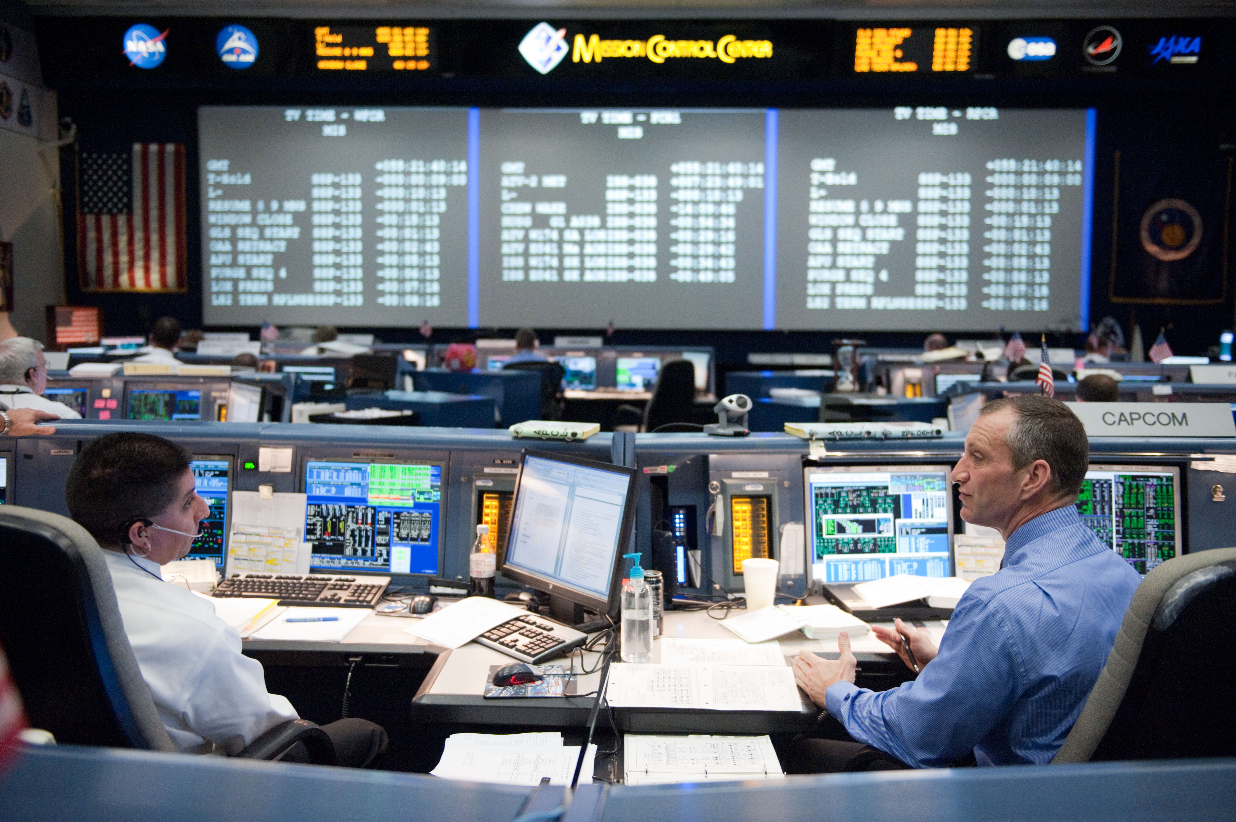 STS-133 flight controllers on console during the launch of Discovery