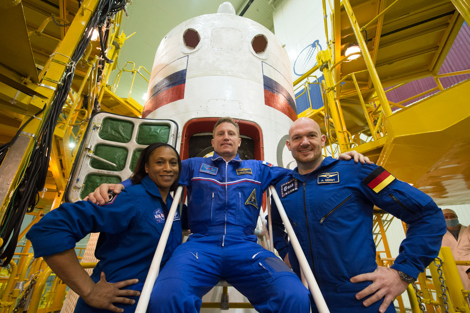 jsc2017e138121 - At the Integration Facility at the Baikonur Cosmodrome in Kazakhstan, the Expedition 54-55 backup crewmembers pose for pictures Dec. 13 in front of the Soyuz MS-07 spacecraft during pre-launch training. Jeanette Epps of NASA (left), Serge