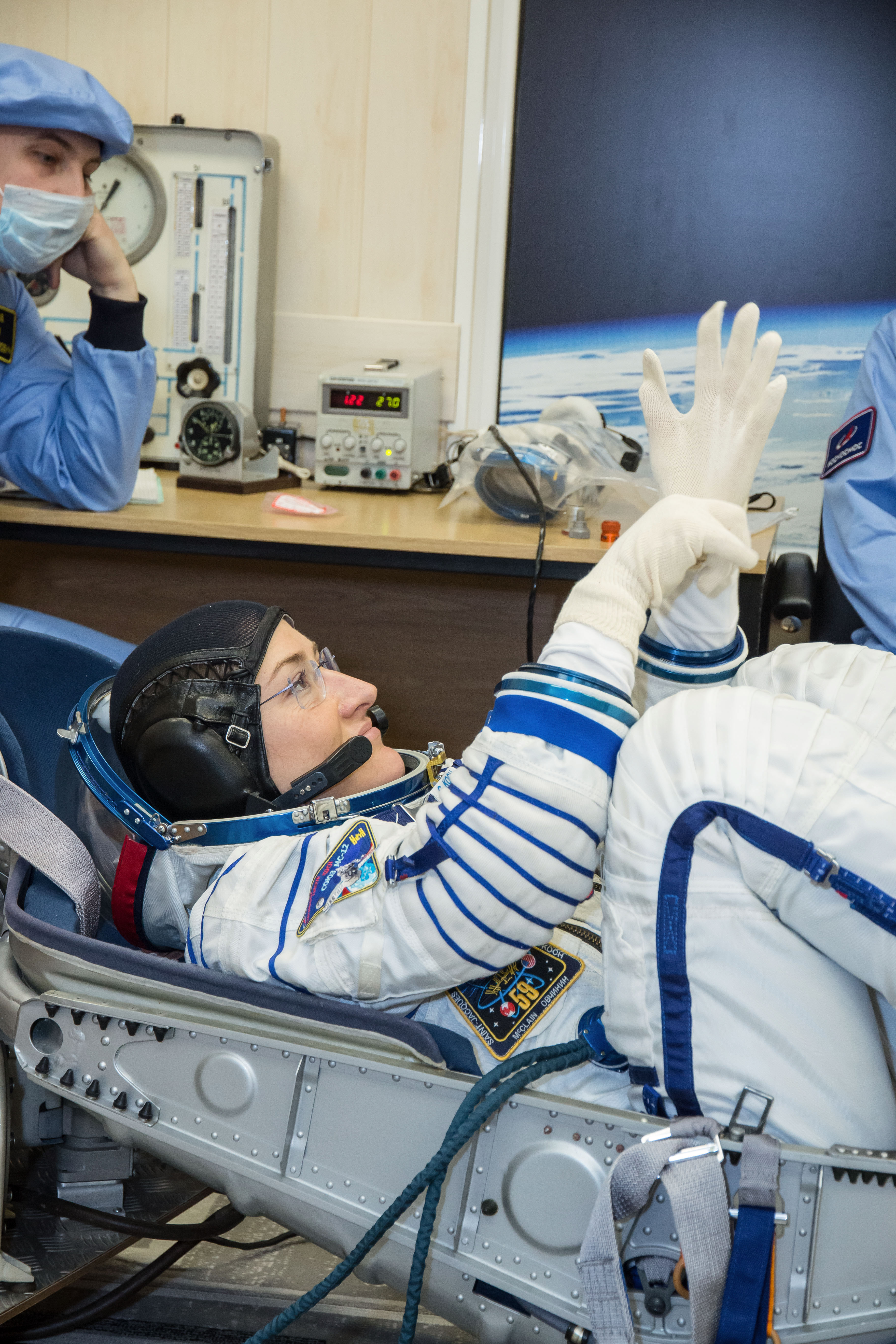jsc2019e009952 - At the Baikonur Cosmodrome in Kazakhstan, Expedition 59 crewmember Christina Koch of NASA undergoes a Sokol launch suit pressure check Feb. 27 during pre-launch training. Koch, Nick Hague of NASA and Alexey Ovchinin of Roscosmos will laun