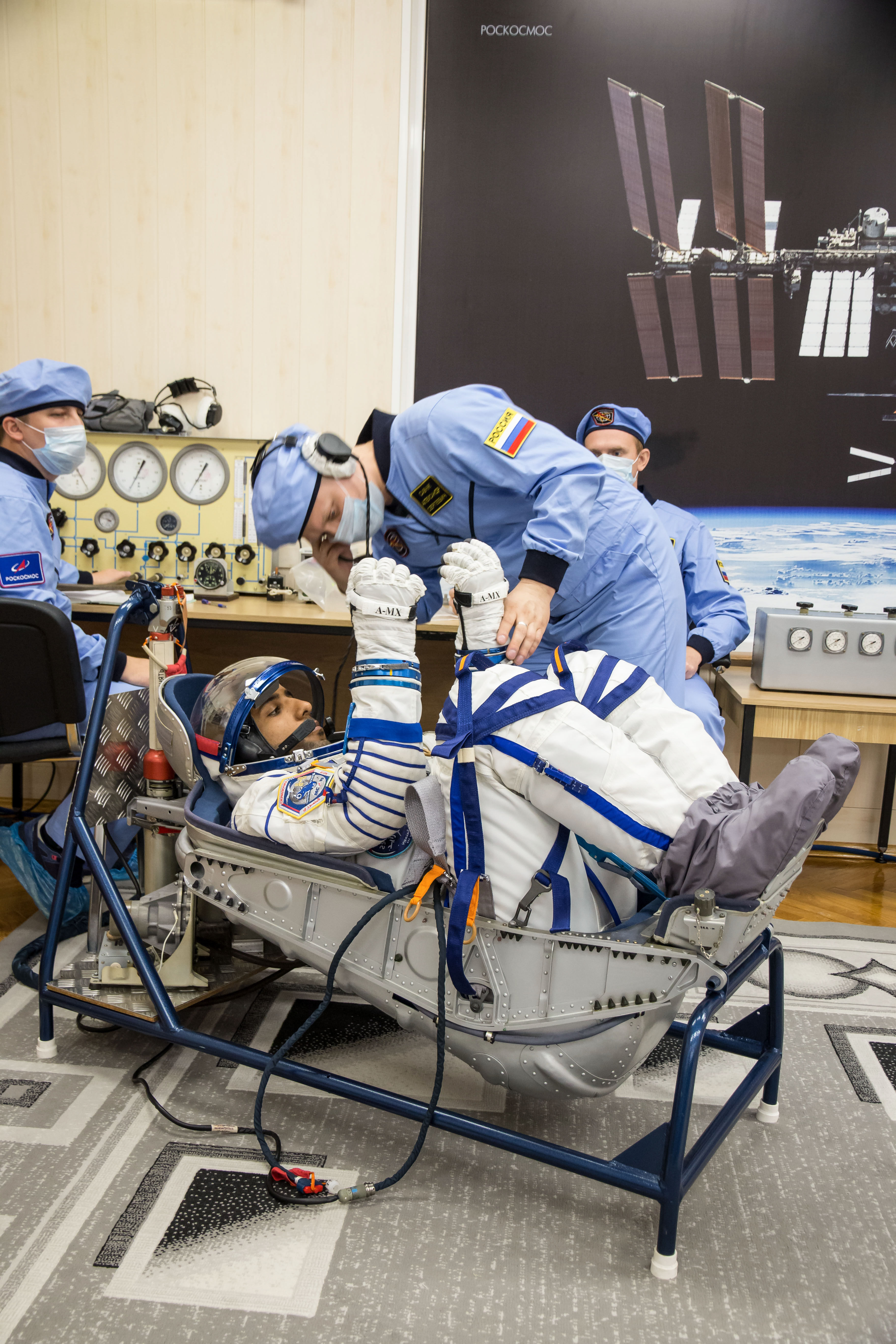 jsc2019e052889 - In the Integration Building at the Baikonur Cosmodrome in Kazakhstan, spaceflight participant Hazzaa Ali Almansoori of the United Arab Emirates undergoes a pressure and leak check of his Russian Sokol launch and entry suit Sept. 11 for a