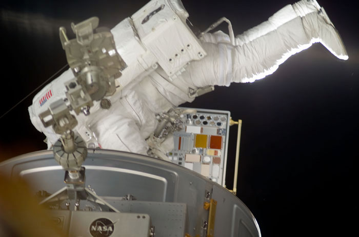 Forrester installs a MISSE PEC on the Airlock Crewlock endcone during EVA