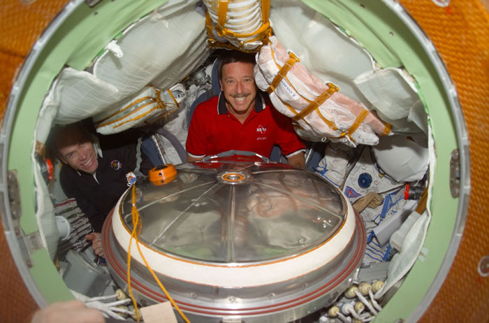 Horowitz and Barry inside Soyuz spacecraft with Sokol suits