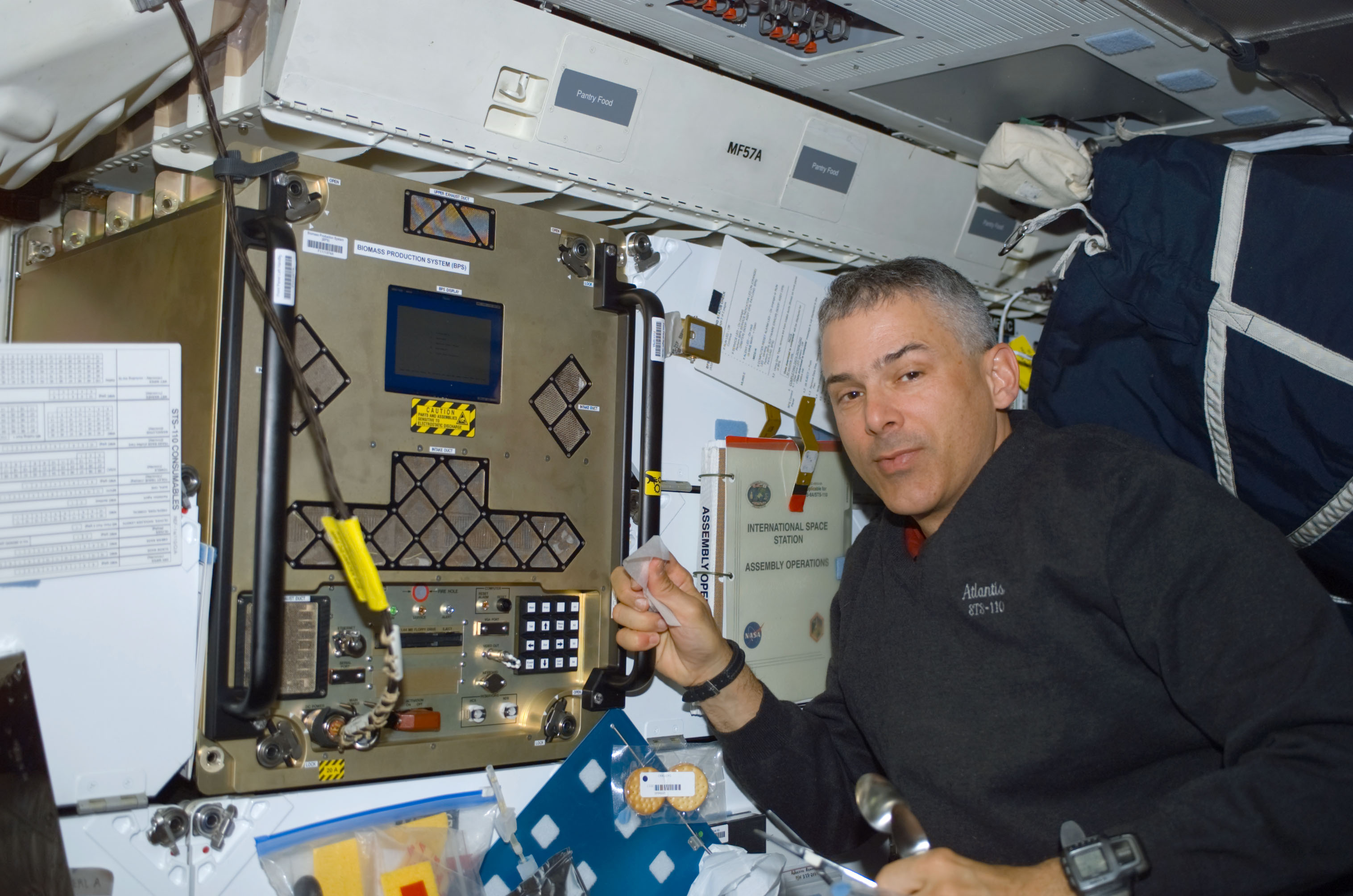 MS Morin works at the BPS experiment on the middeck of Atlantis during STS-110