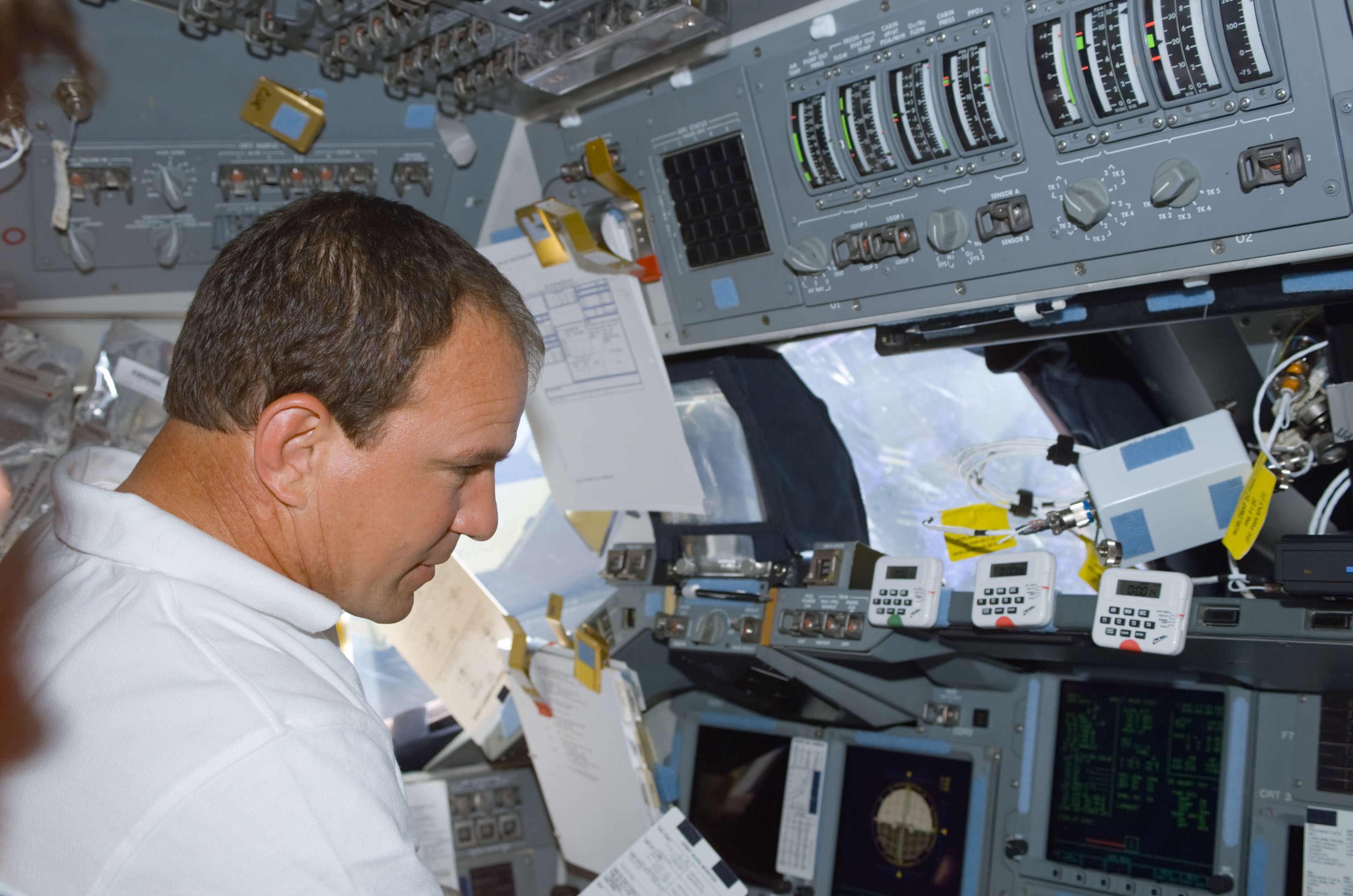 Commander Bloomfield works at the commander's workstation on the flight deck during STS-110