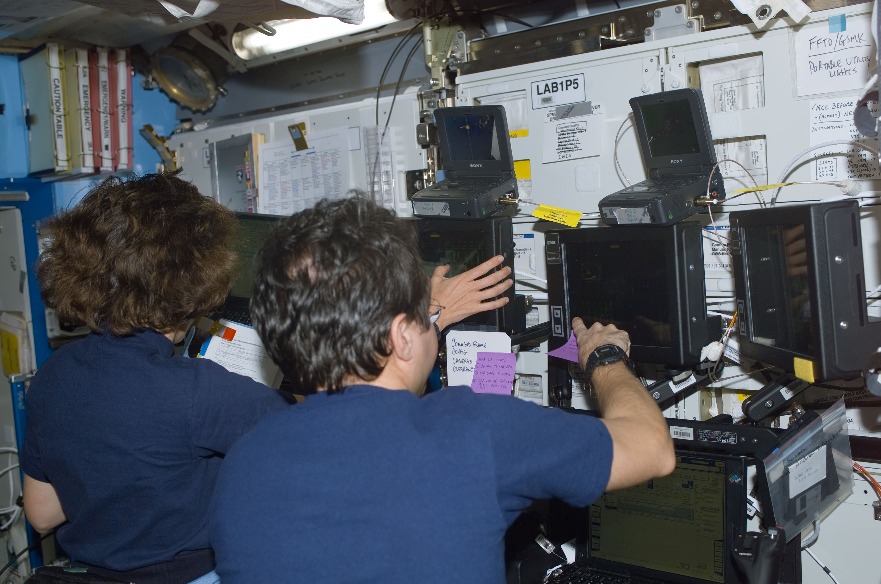 Bursch and Ochoa at the SSRMS controls in Destiny during S0 Truss installation on the ISS