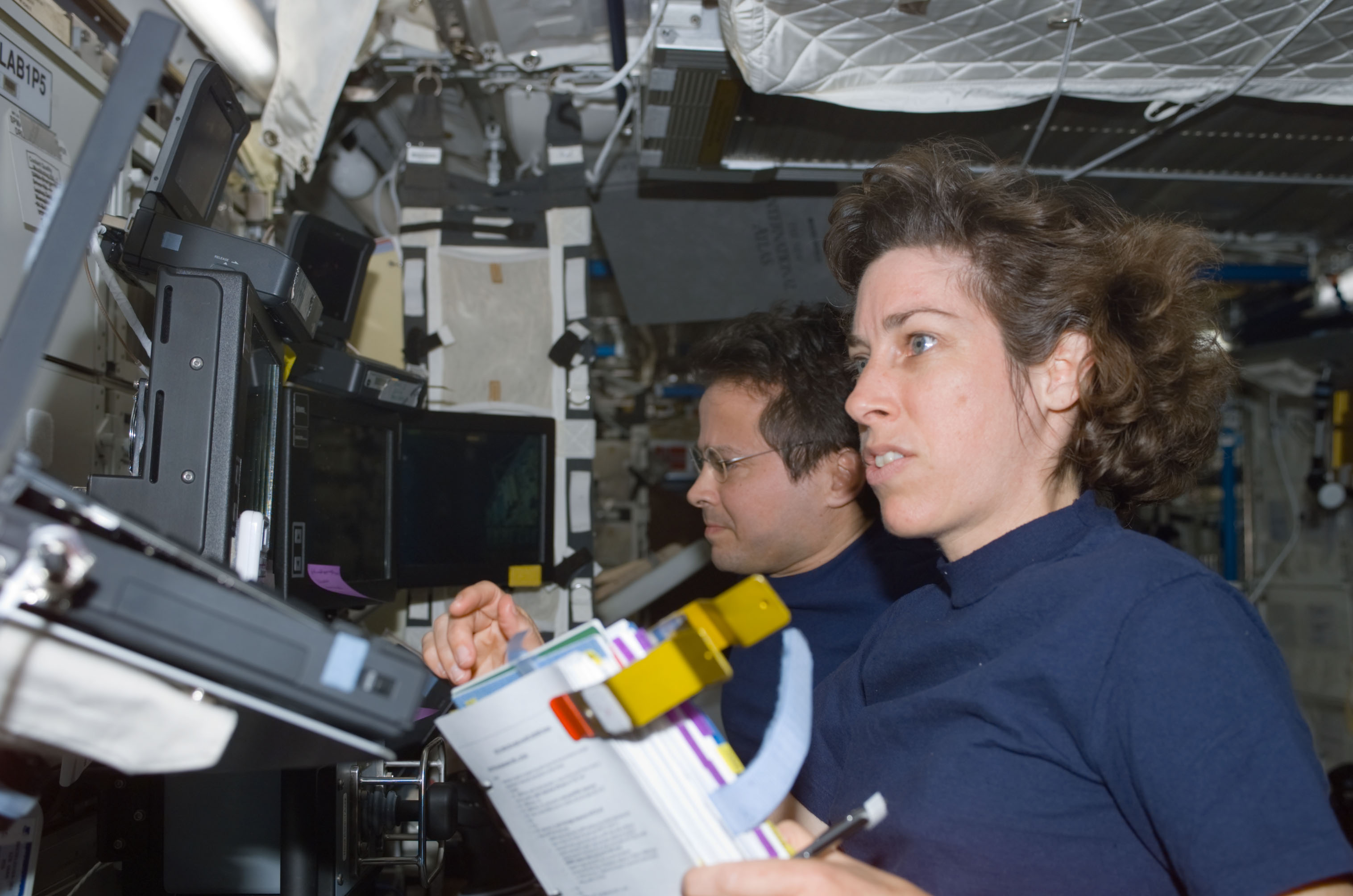 Bursch and Ochoa at the SSRMS controls in Destiny during S0 Truss installation on the ISS