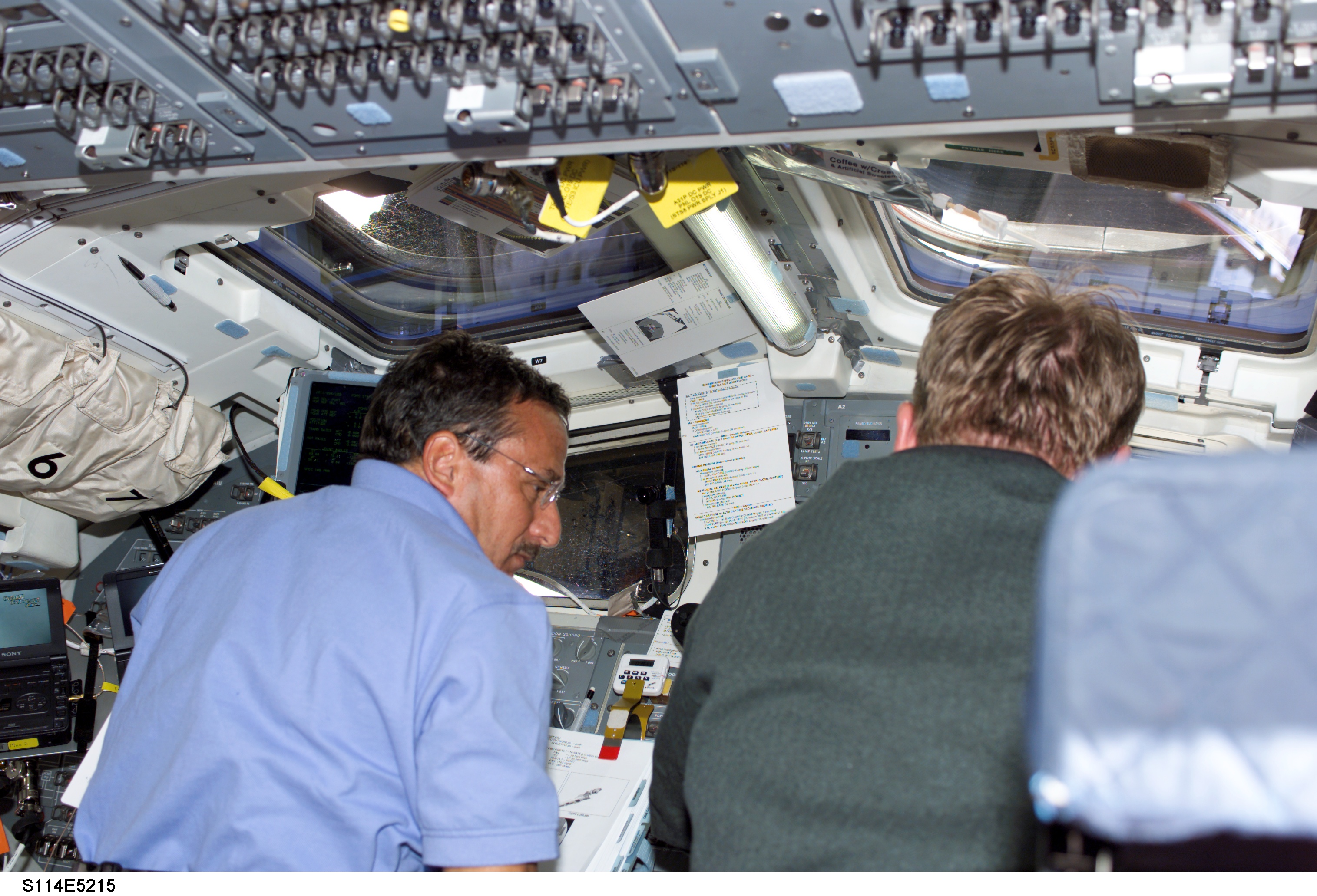 STS-114 Mission specialists Thomas and Camarda on aft flight deck.