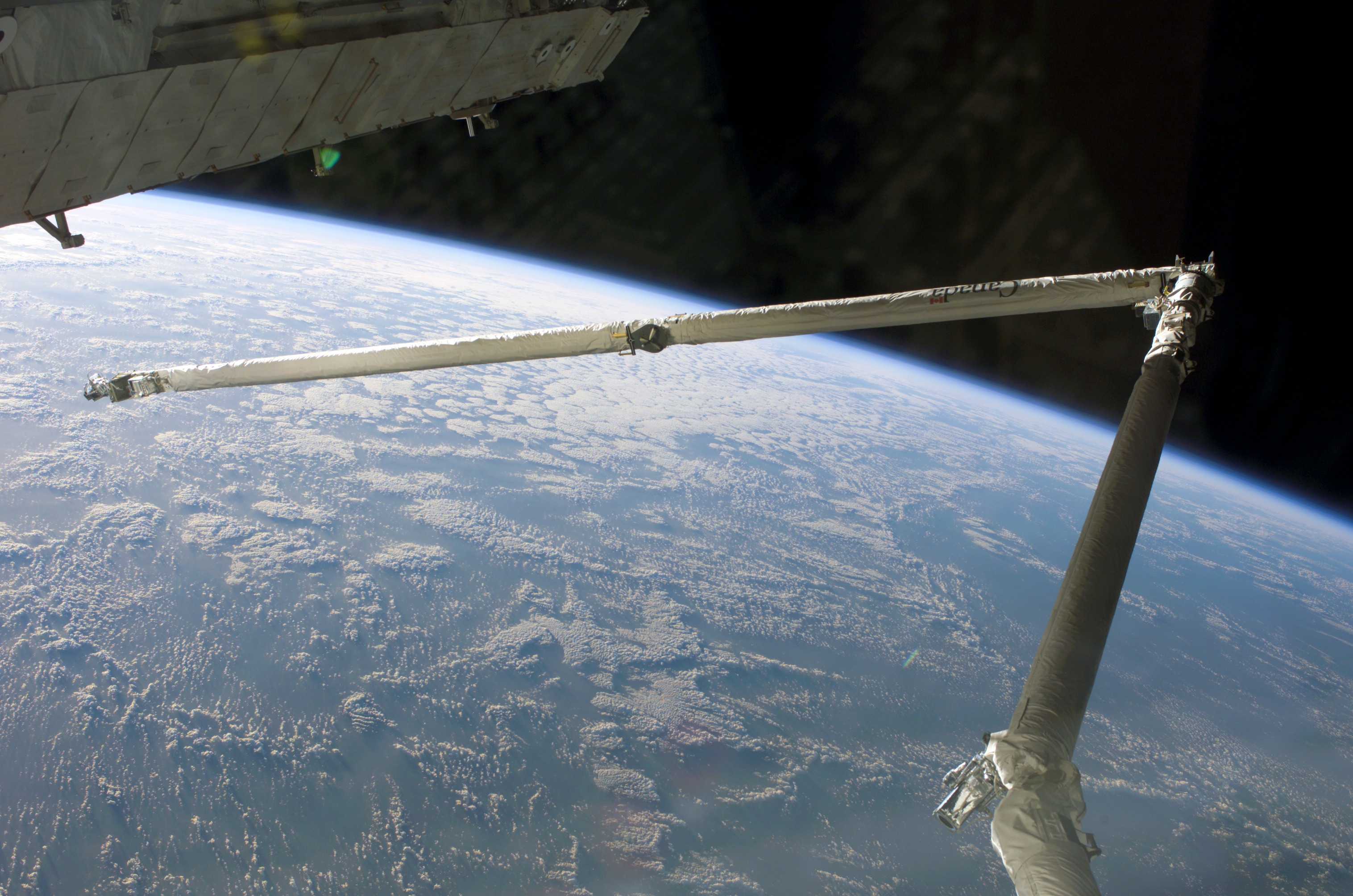 Orbital Boom Sensor System with a cloudy Earth limb