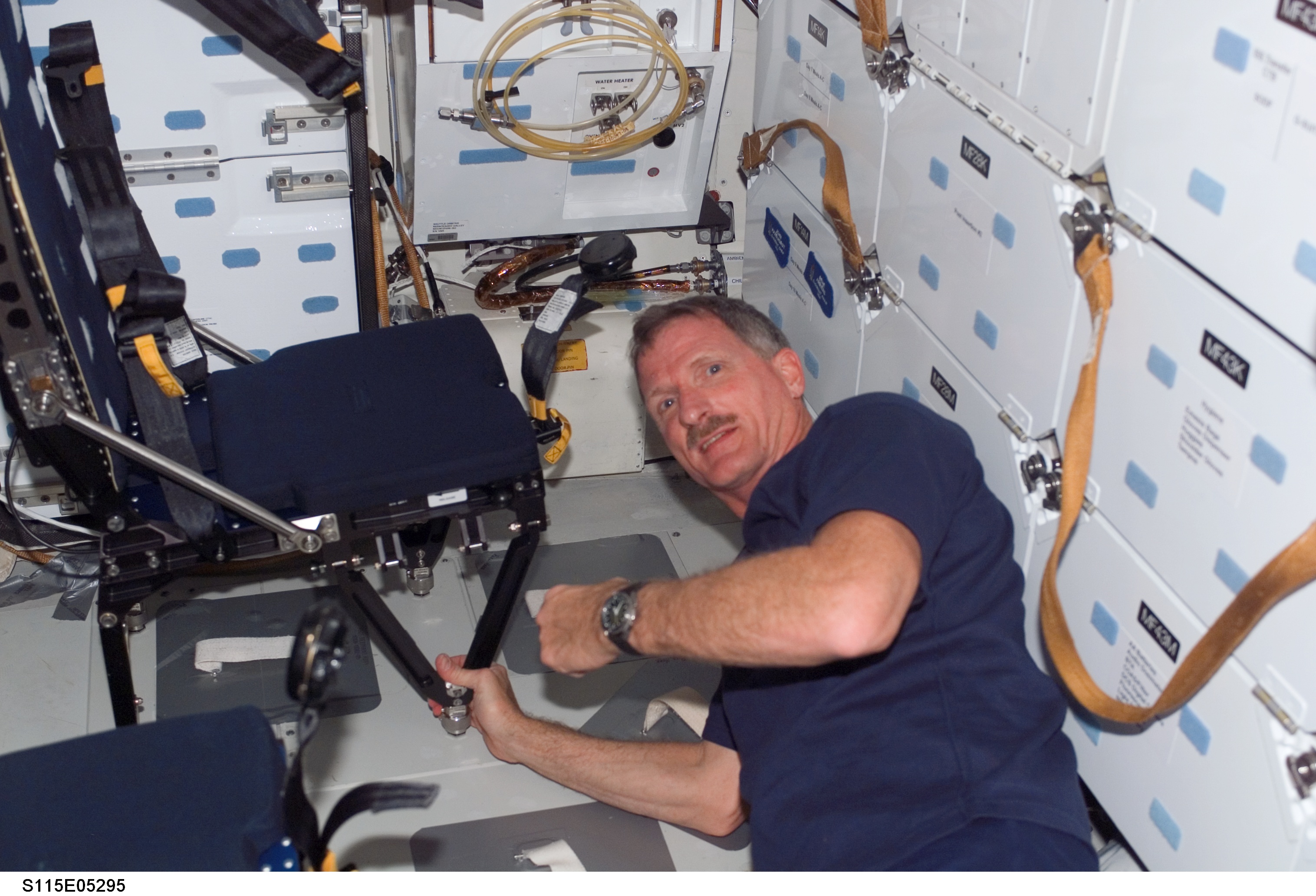 STS-115 MS Tanner prepares to remove LES seat on Atlantis Middeck