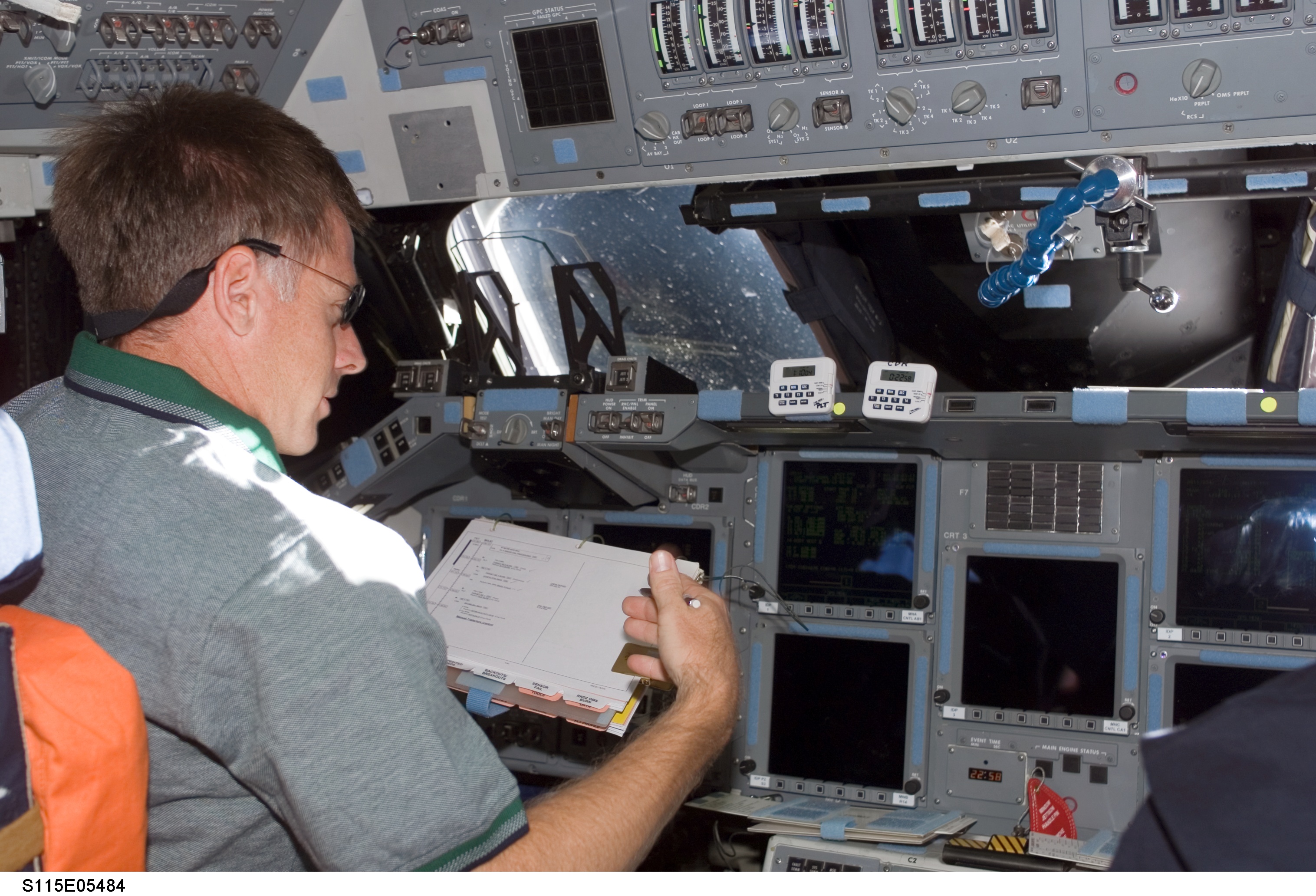 Ferguson looks at crew procedures on the FD of the Space Shuttle Atlantis during STS-115