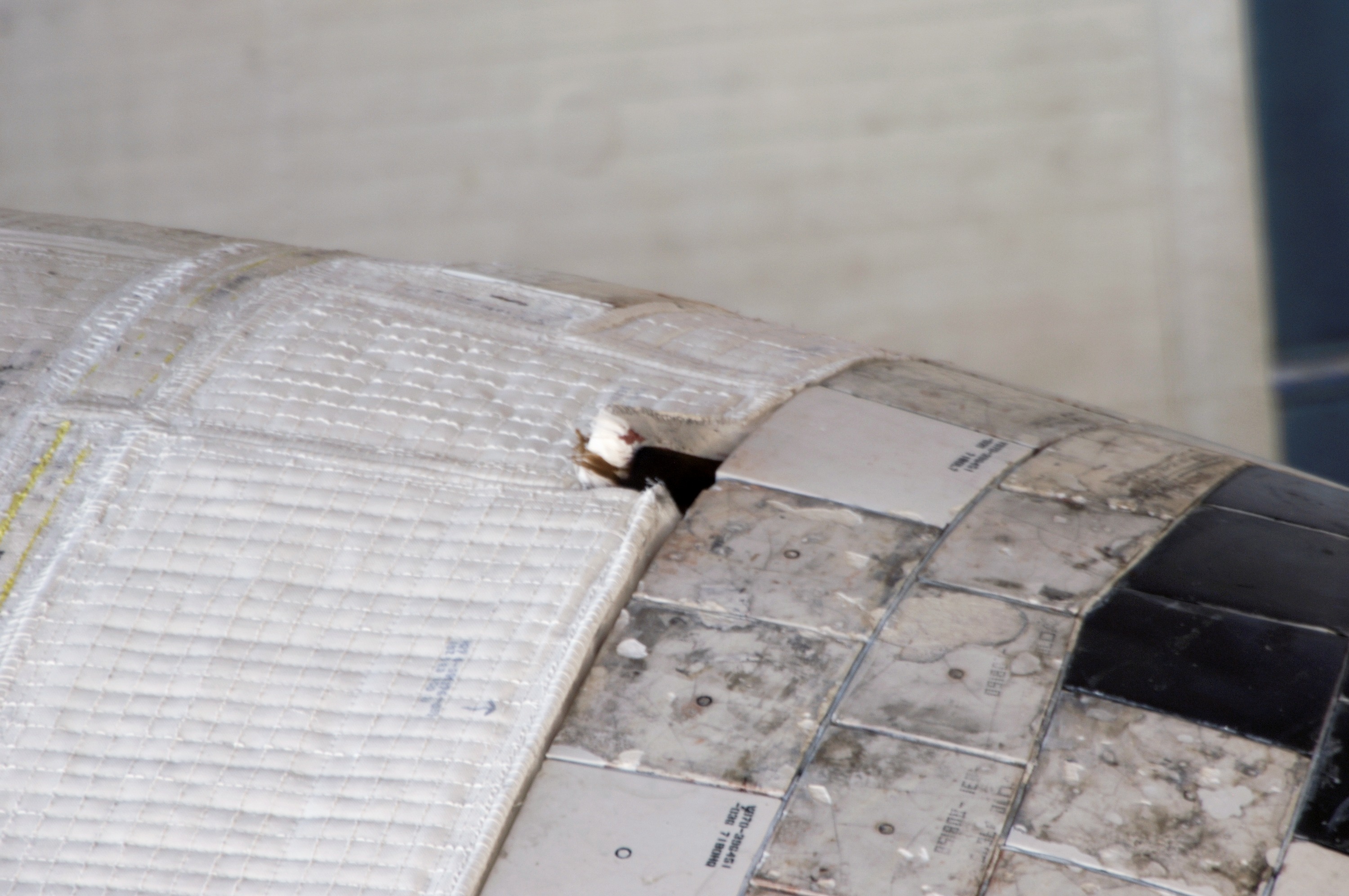 Damaged thermal blanket noted on port OMS Pod on STS-117 Space Shuttle Atlantis