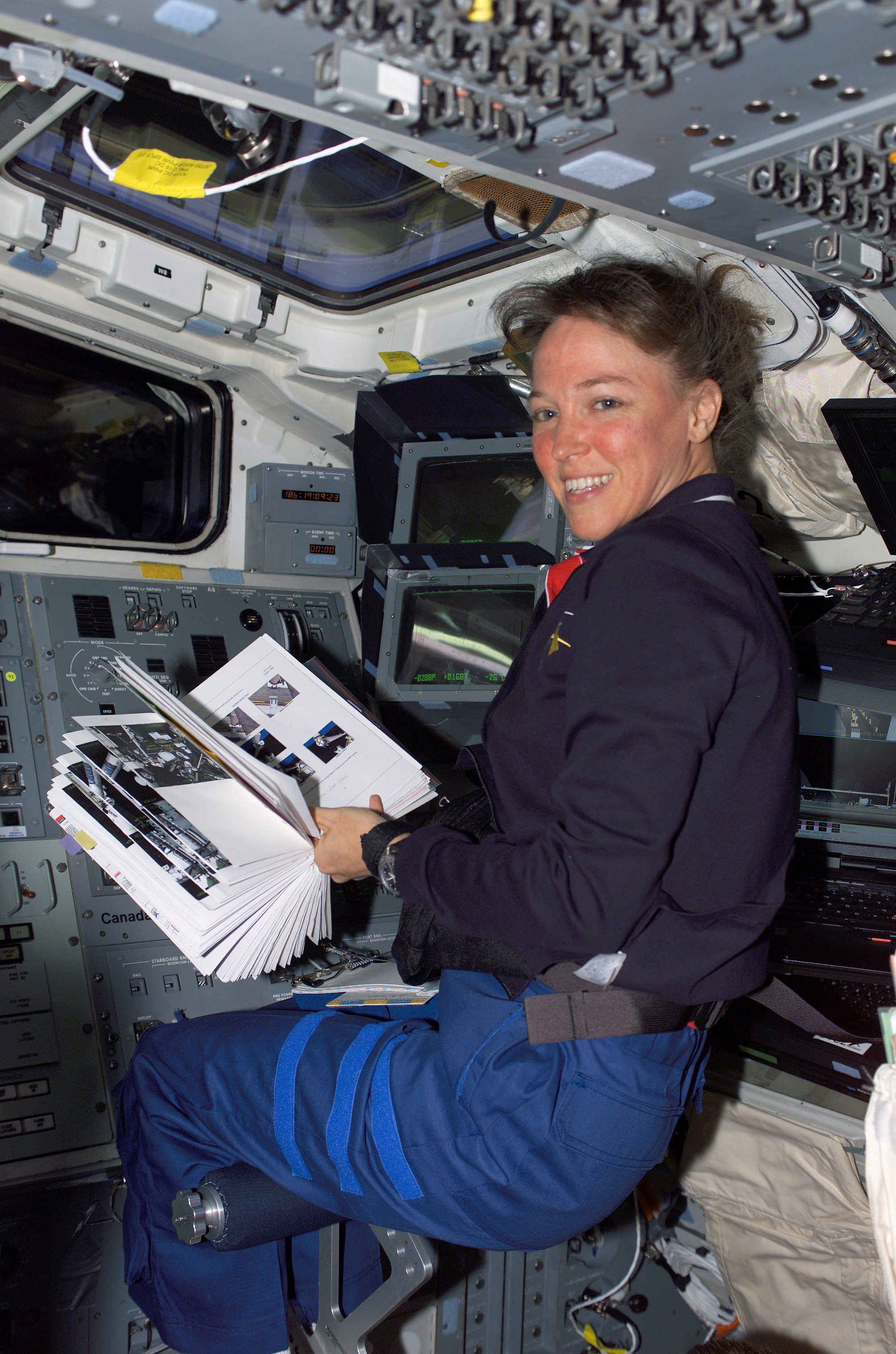 Nowak reads a checklist during OBSS berthing operations on STS-121