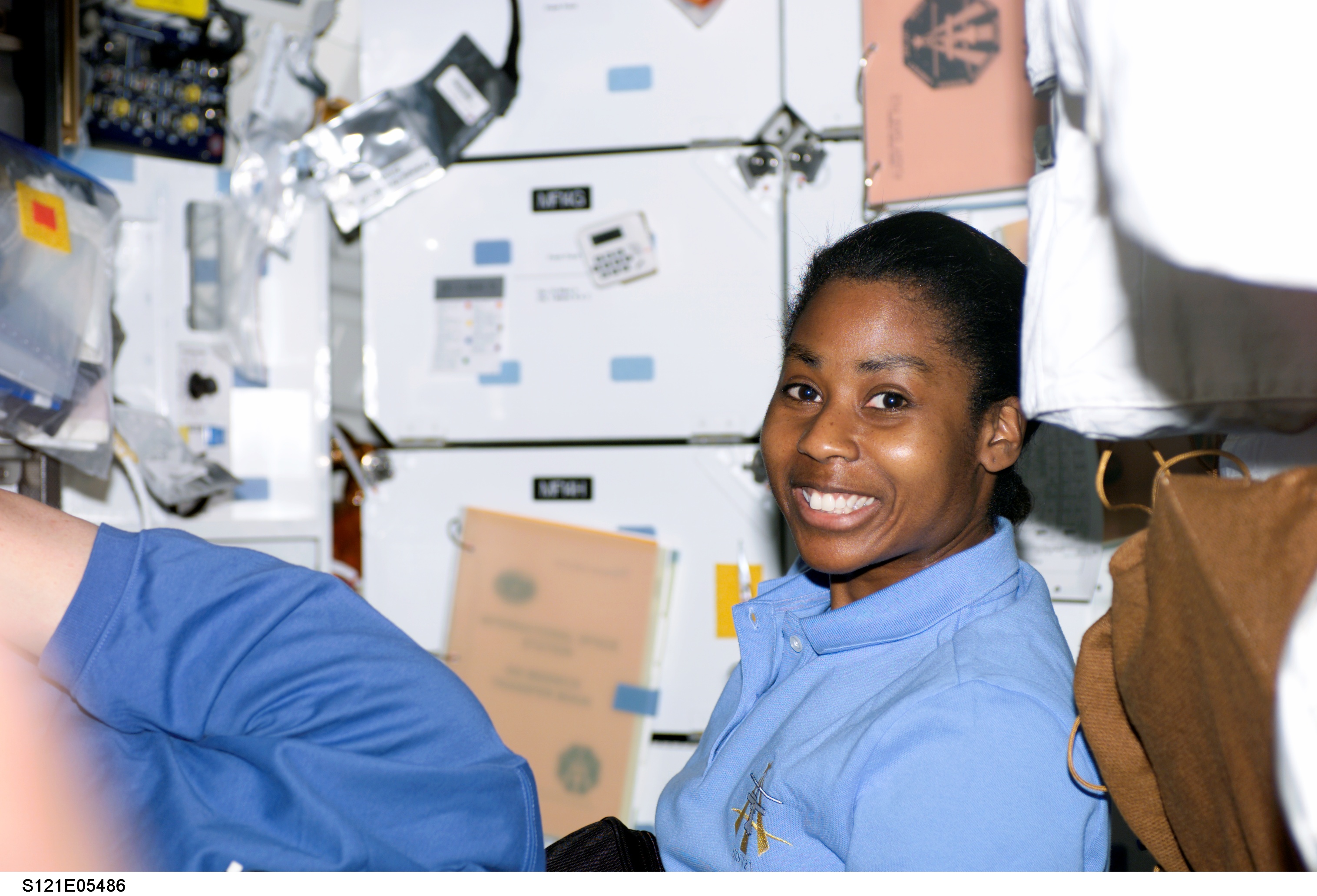 Wilson, smiles at the camera in the MDK during STS-121