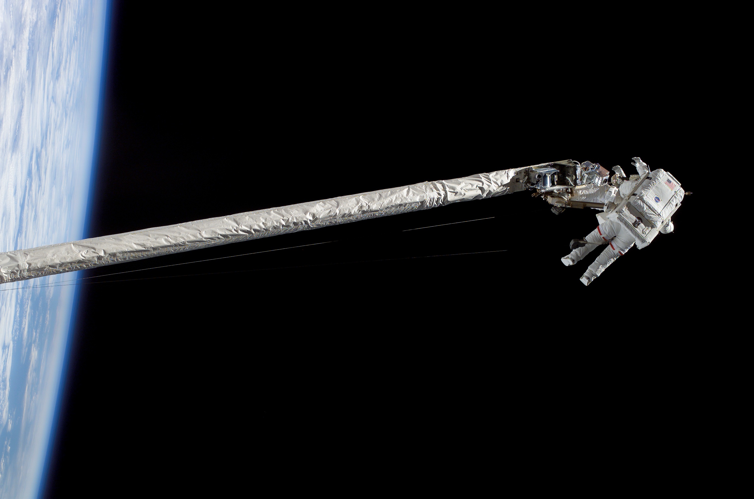 Fossum and Sellers on the OBSS during EVA1 on STS-121 / Expedition 13 joint operations