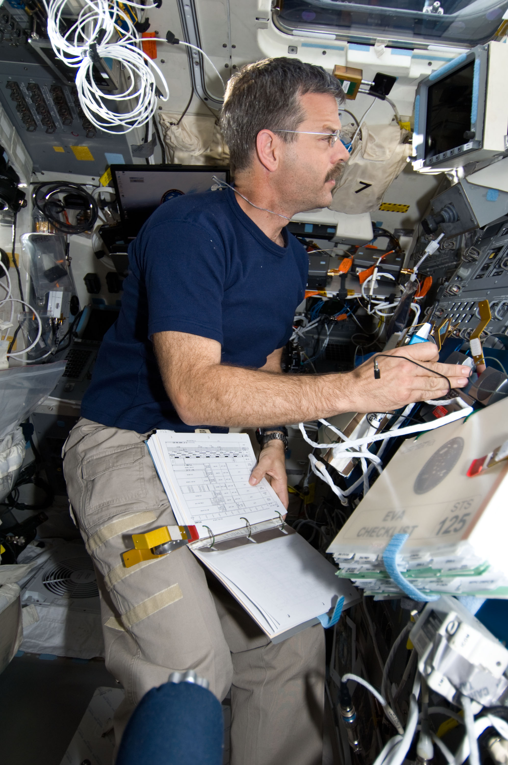 STS-125 CDR Altman working on the Flight Deck