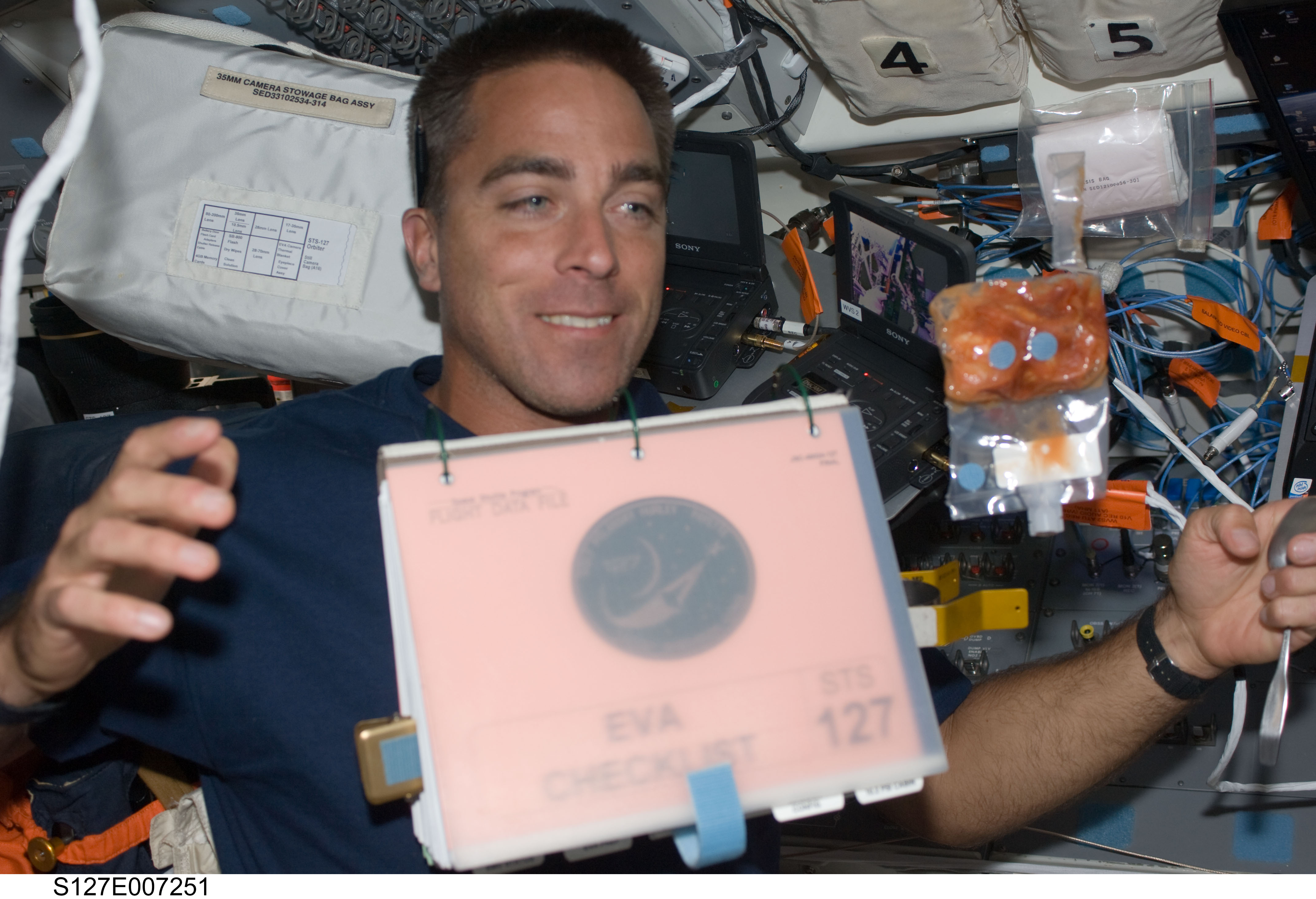 Cassidy watches a checklist float in the FD during STS-127 / Expedition 20 Joint Operations
