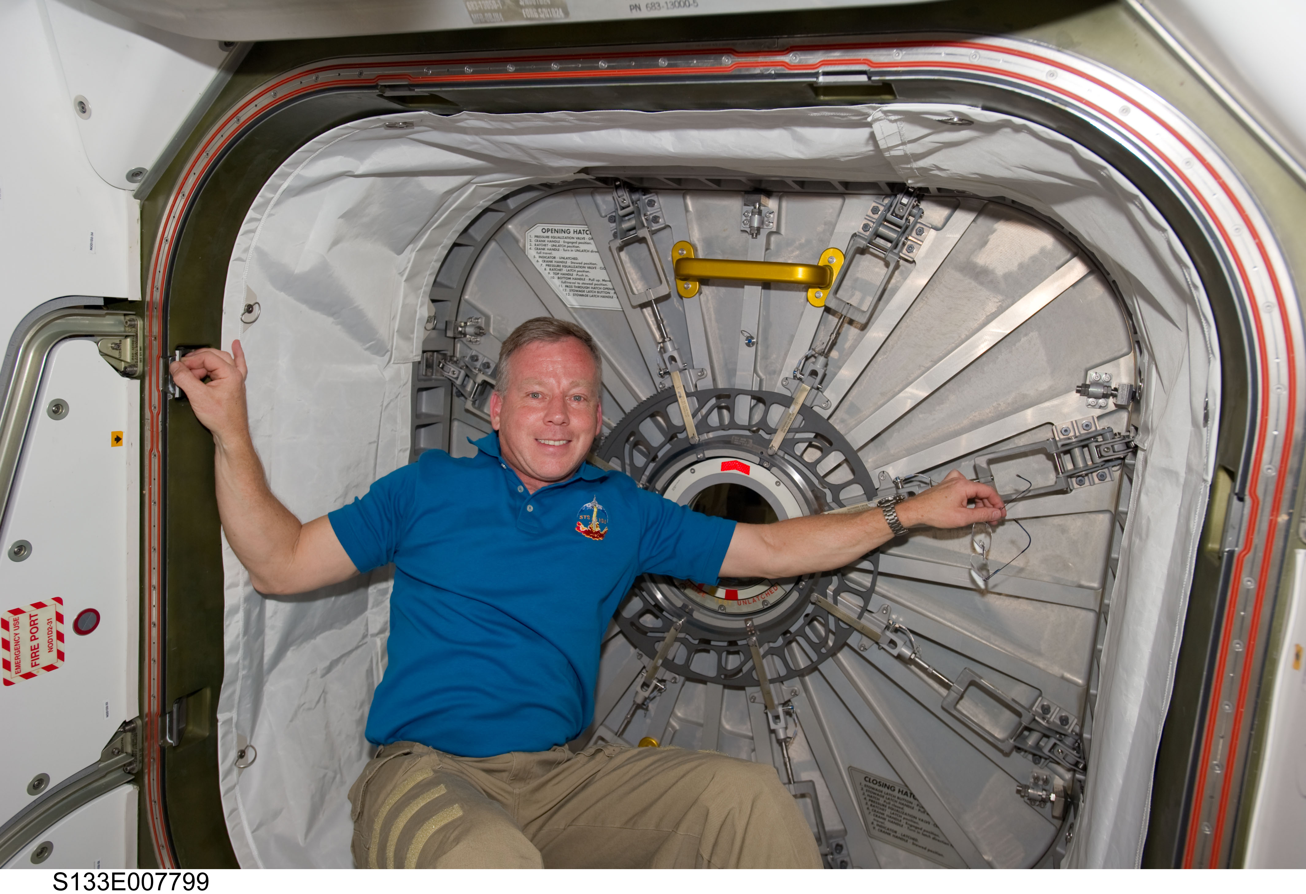Lindsey beside hatch to PMM (Permanent Multipurpose Module)