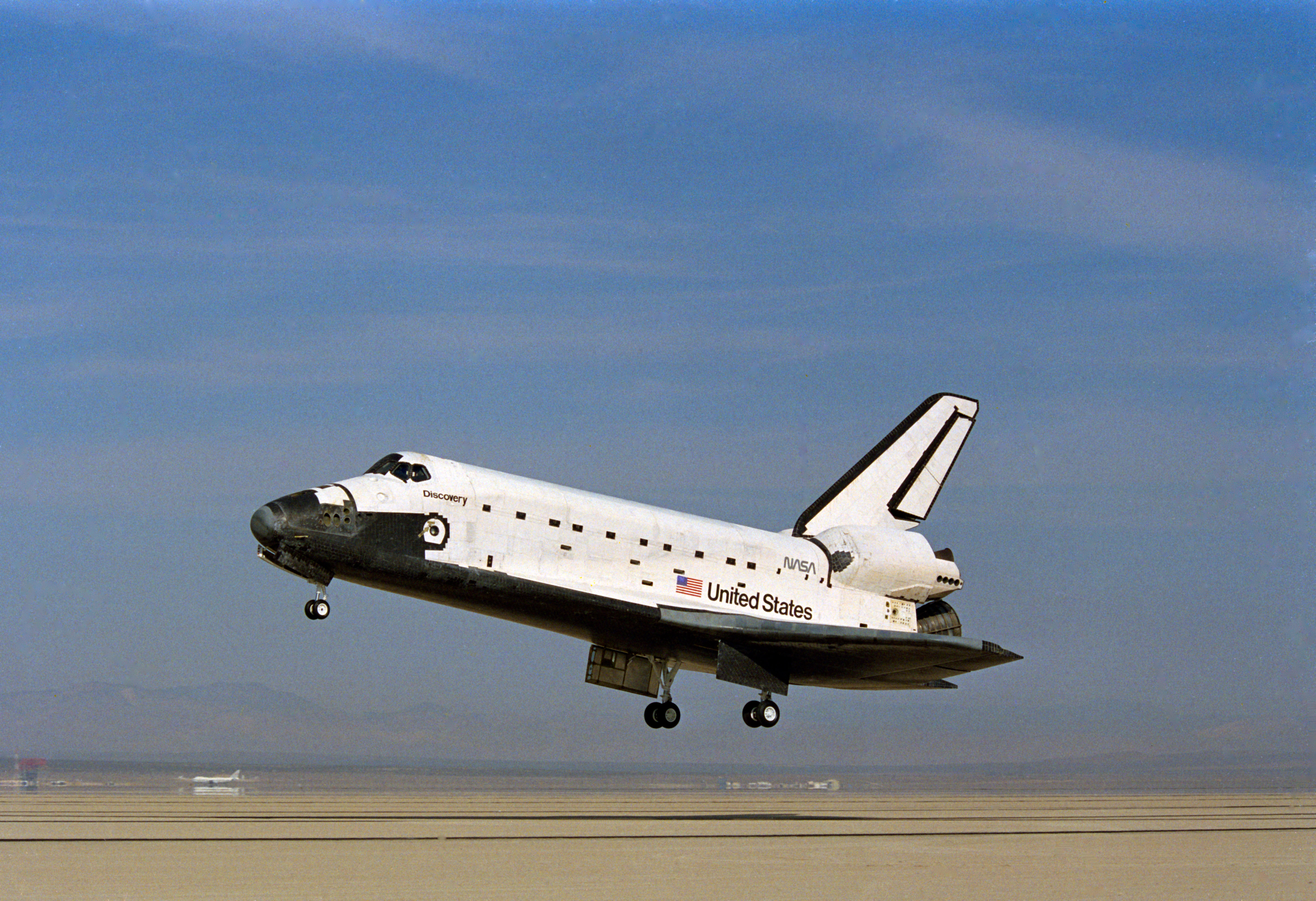 STS-26 Discovery, OV-103, with landing gear deployed glides above EAFB runway