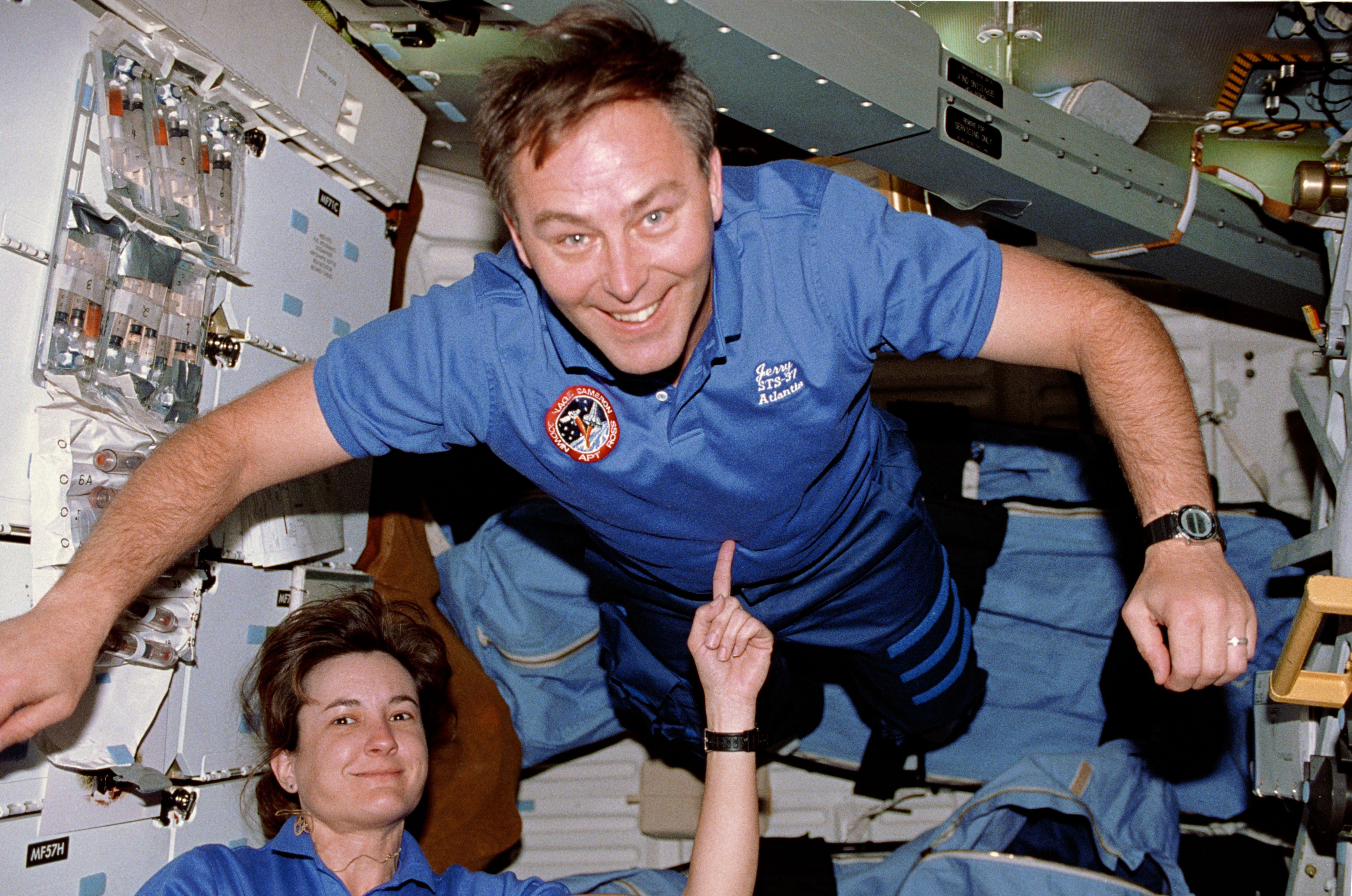 STS-37 MS Godwin balances MS Ross using her index finger on OV-104's middeck