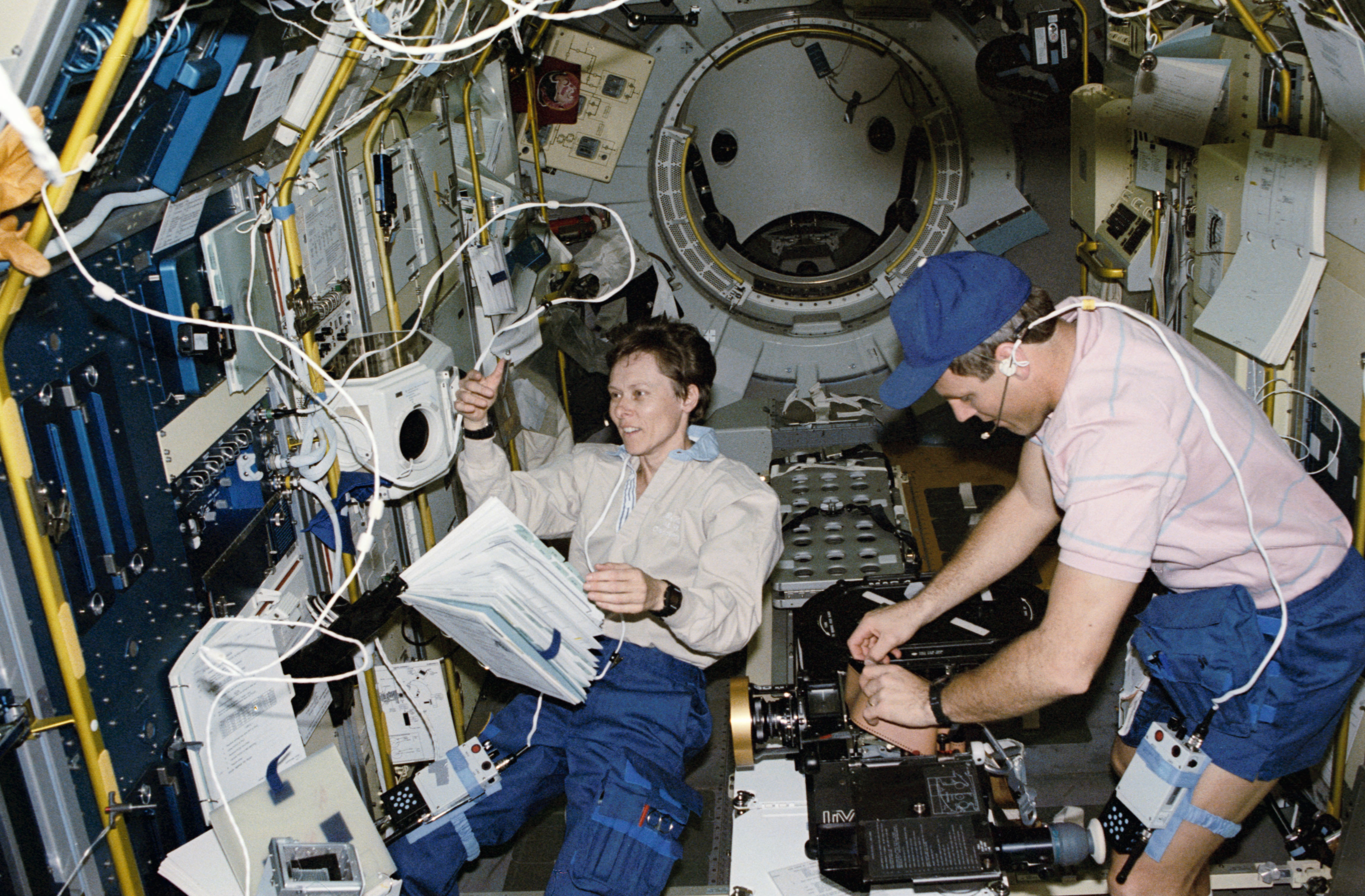 STS-42 crewmembers work in the IML-1 module located in OV-103's payload bay