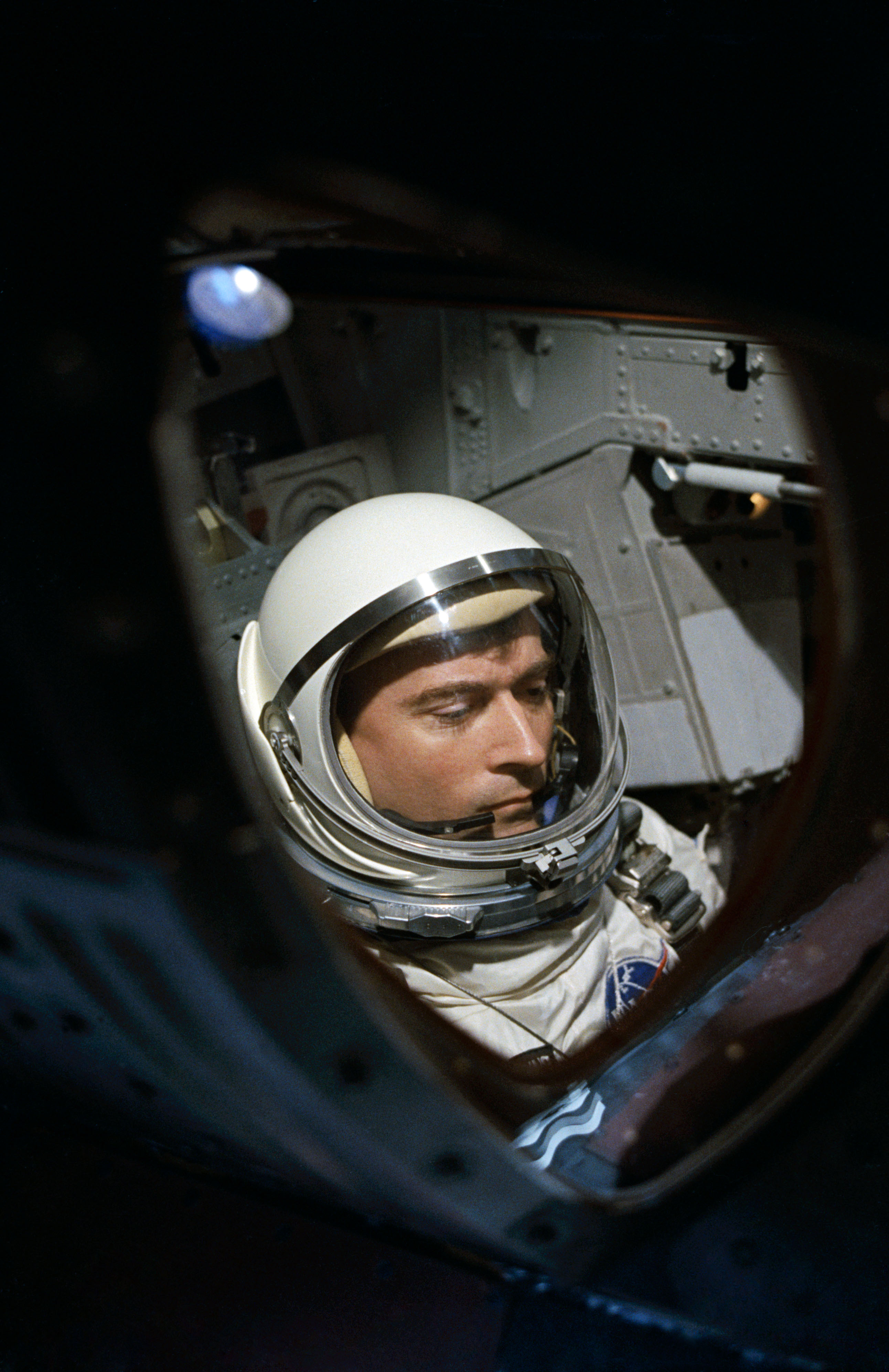View of Astronaut John Young through spacecraft window prior to launch
